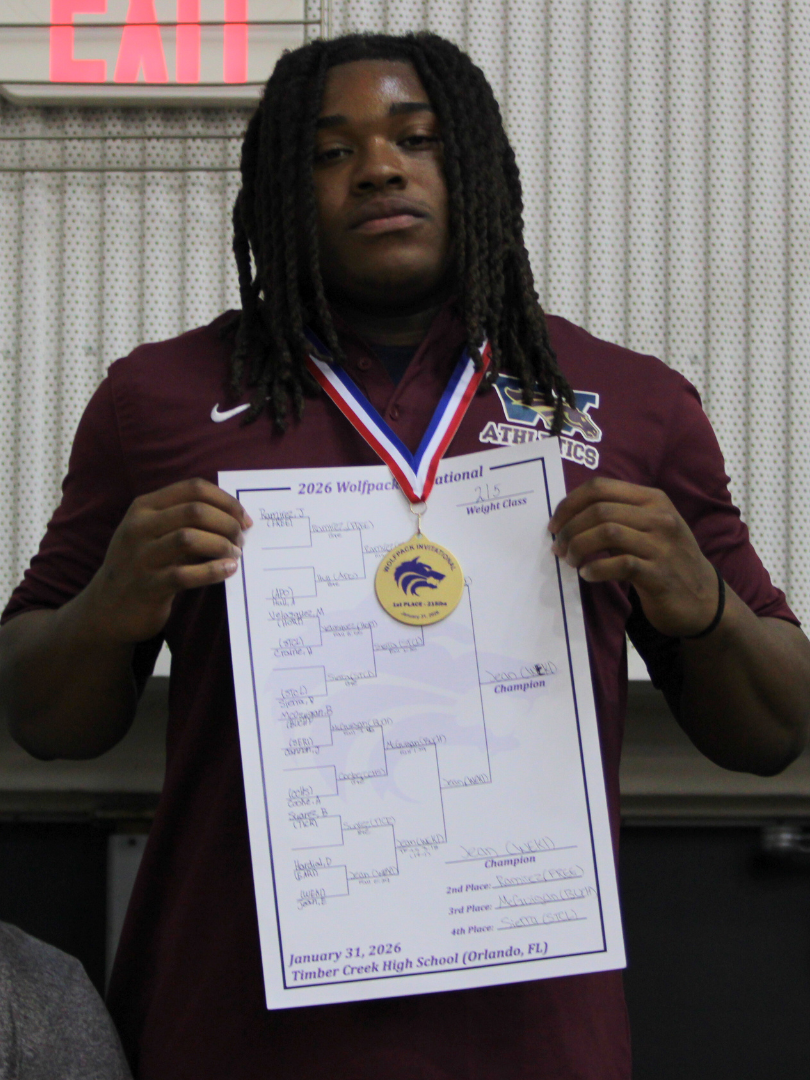 Elijah Jean stands at the podium with his gold medal