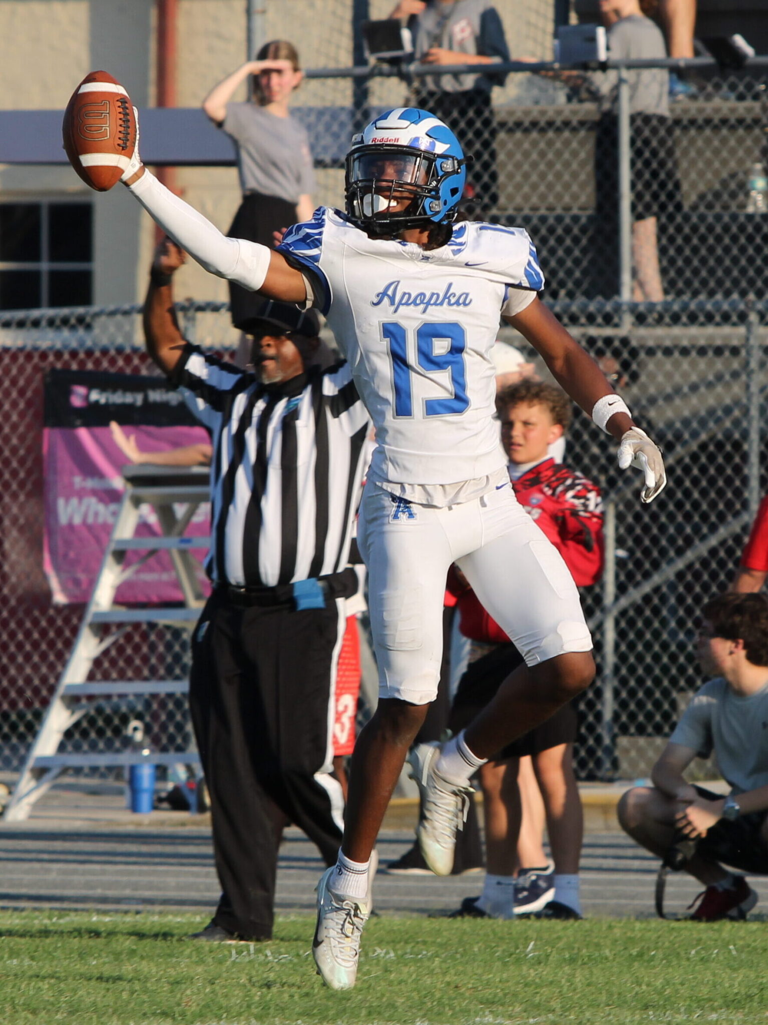 Ezra Dady flashes out the football to show his sideline that they recovered the fumble