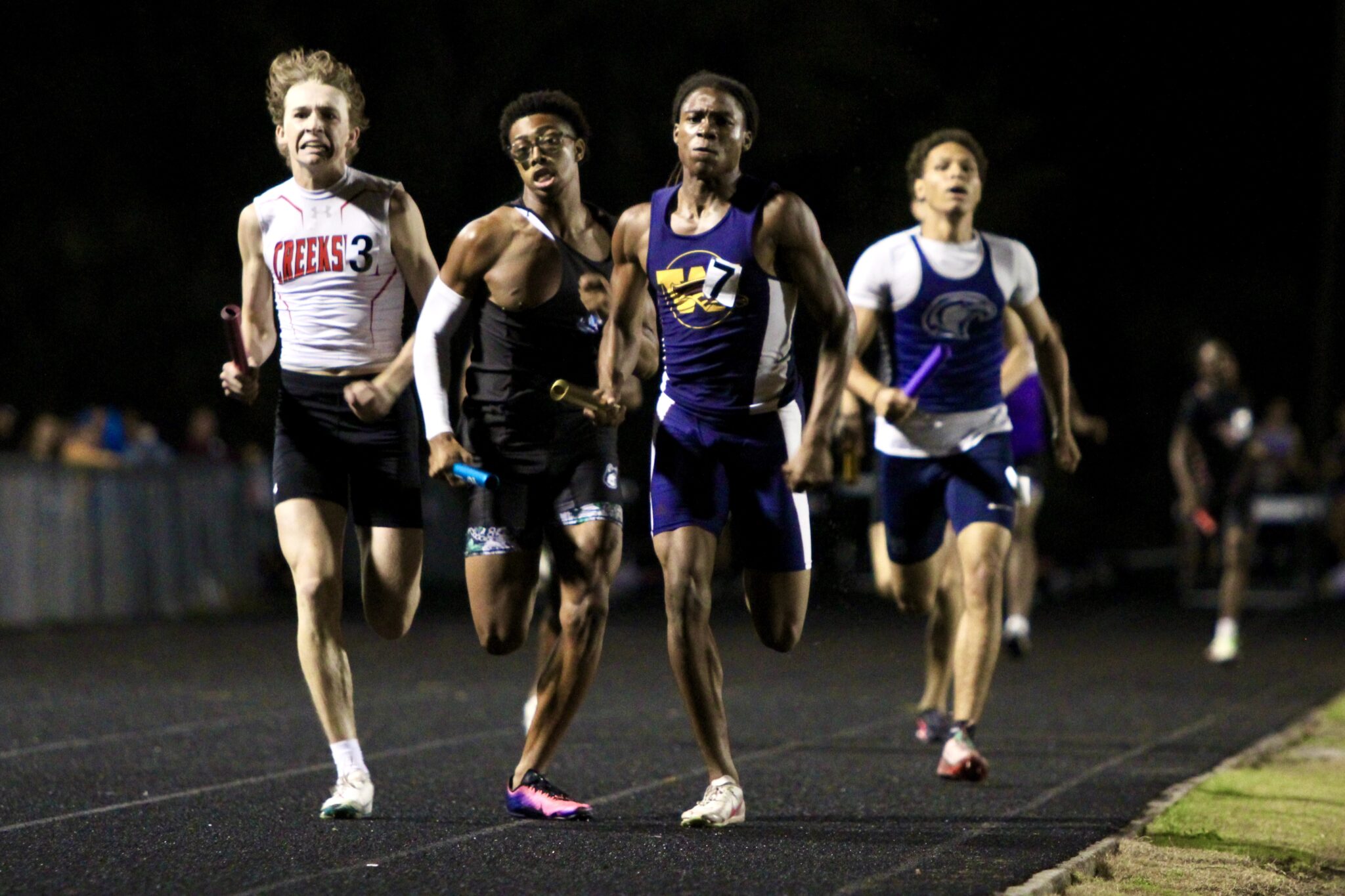 Khai Orr sprints ahead of the field in the third leg of the 4x400m relay