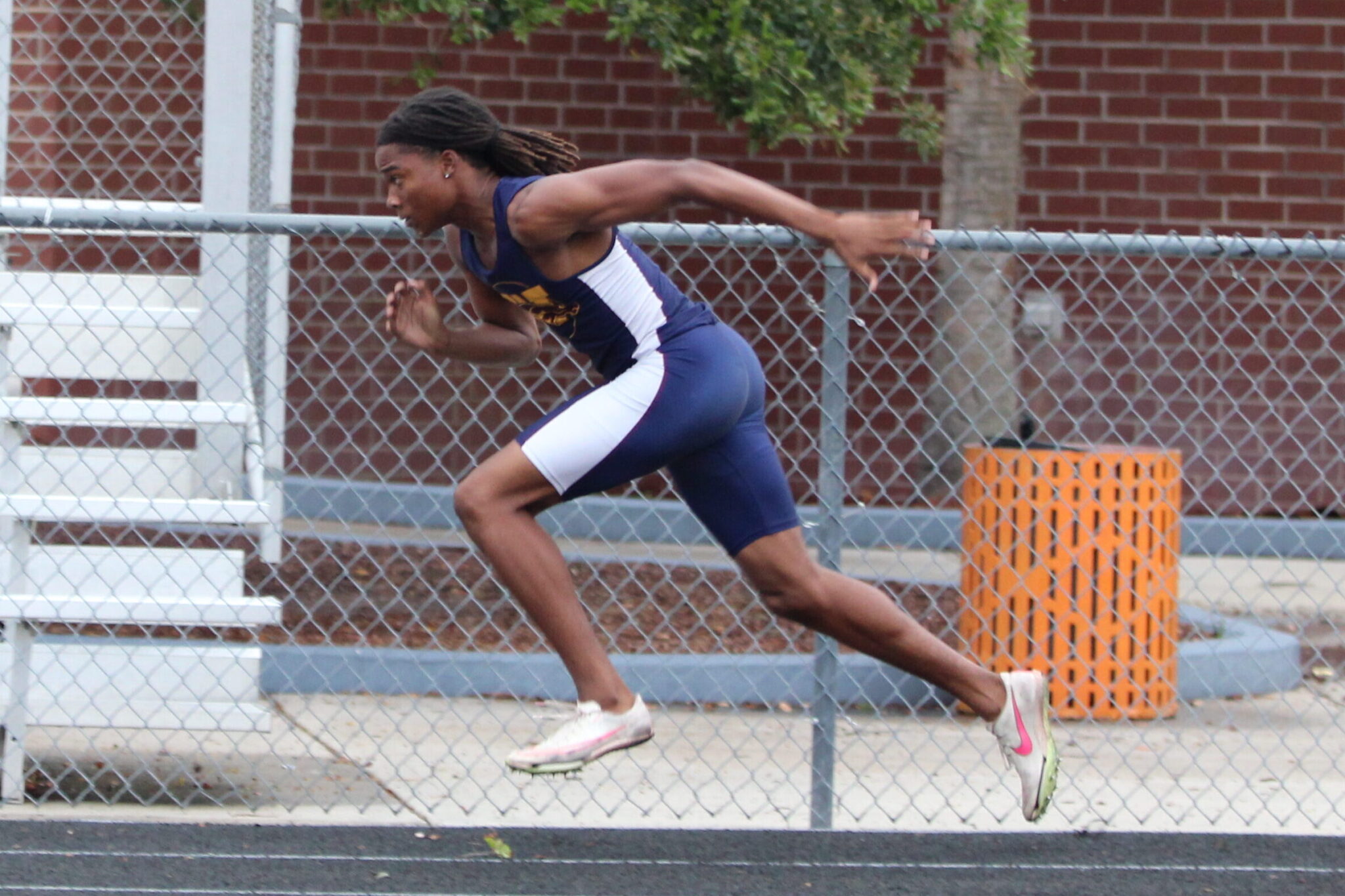 Khai Orr takes a head start before getting the baton handed to him on the second leg of the 4x100 relay