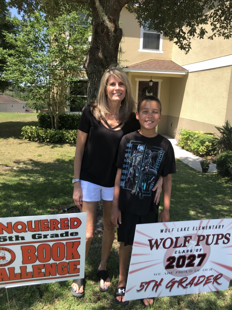 Mary Block poses with former student April Ware's son.