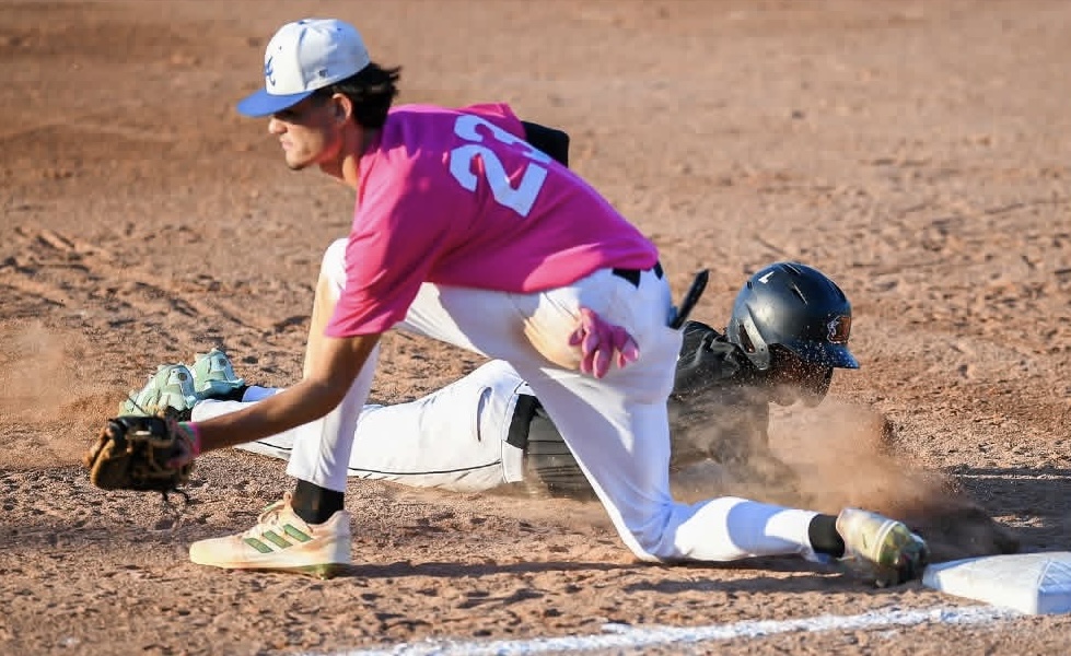 Tyler Spaid snags a low throw at first in attempt to pick off the runner.