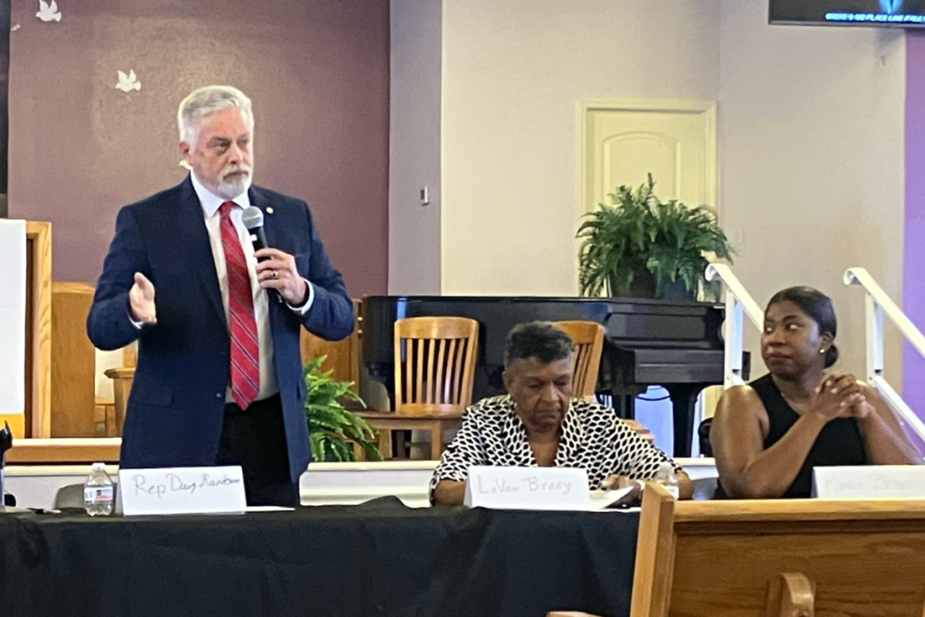during a Thursday town hall discussion on redistricting and voting rights at St. Paul AME Church in Apopka. Seated beside him are educator and civil rights advocate Dr. Lavon Wright Bracy (center) and former state Rep. Kamia Brown (right).