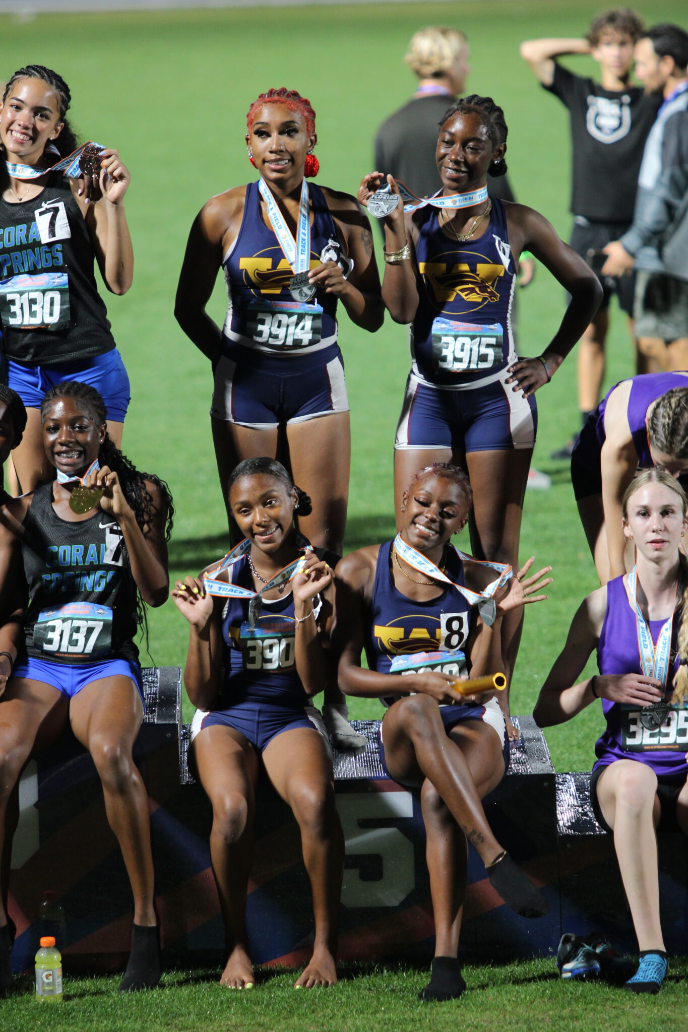 Wekiva girls 4x400m relay flashes their medals at the podium