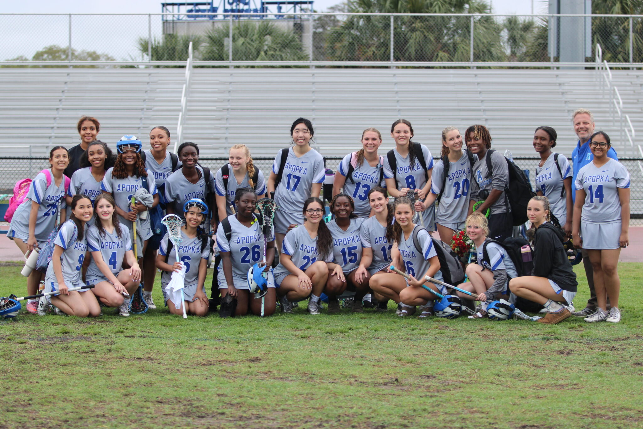 Apopka Blue Darters girls lacrosse team poses after their senior night game with Principle Heinz