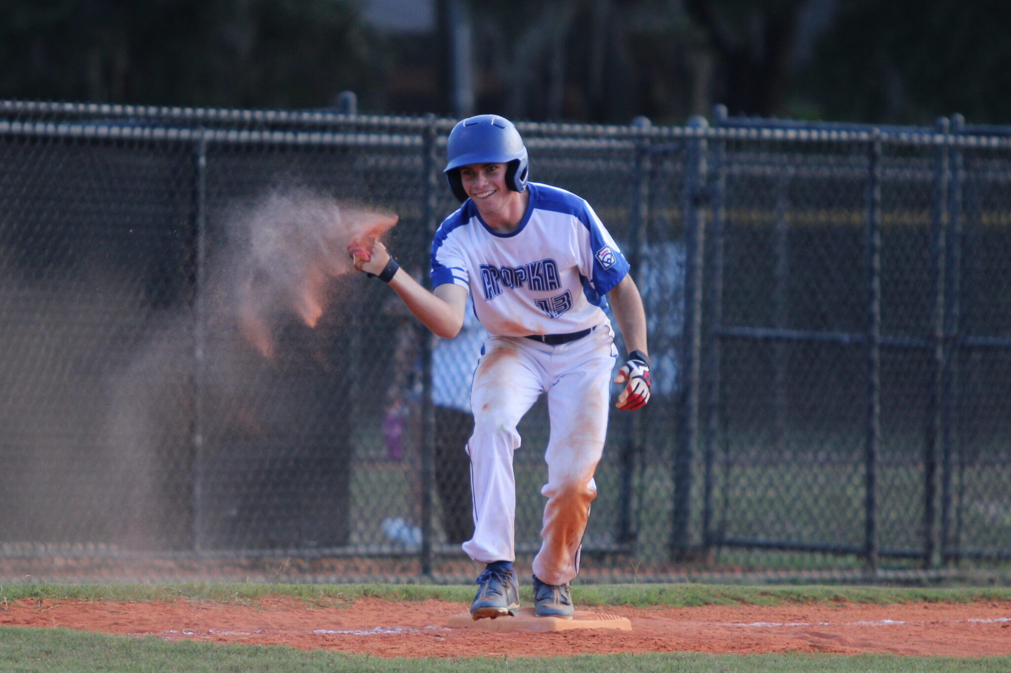 Austin Furgala tosses dirt for his dugout in celebration of his 2 RBI triple that ended the game.