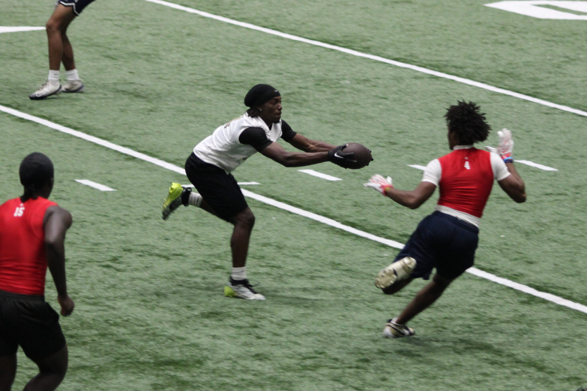 Bakary Manley snags a ball out from in front of a defender at midfield.