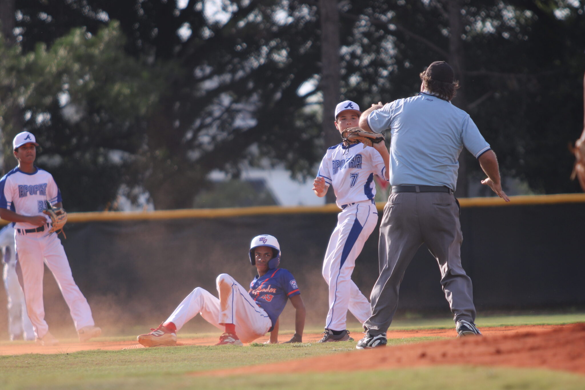 Brandon Ray shows the umpire his glove after applying the tag for an out at second base.