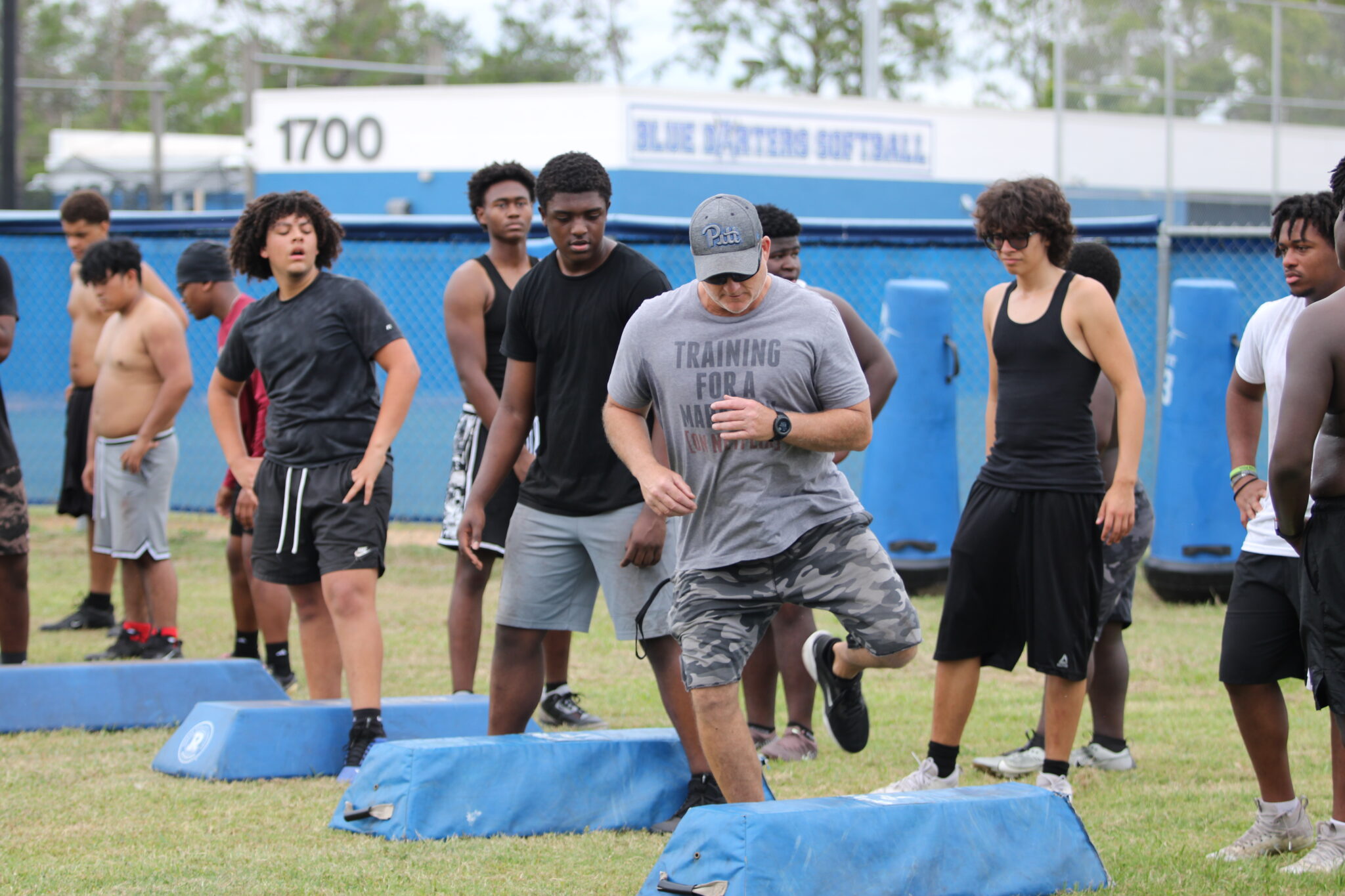 Coach Matt Anderson works on-field with his unit.