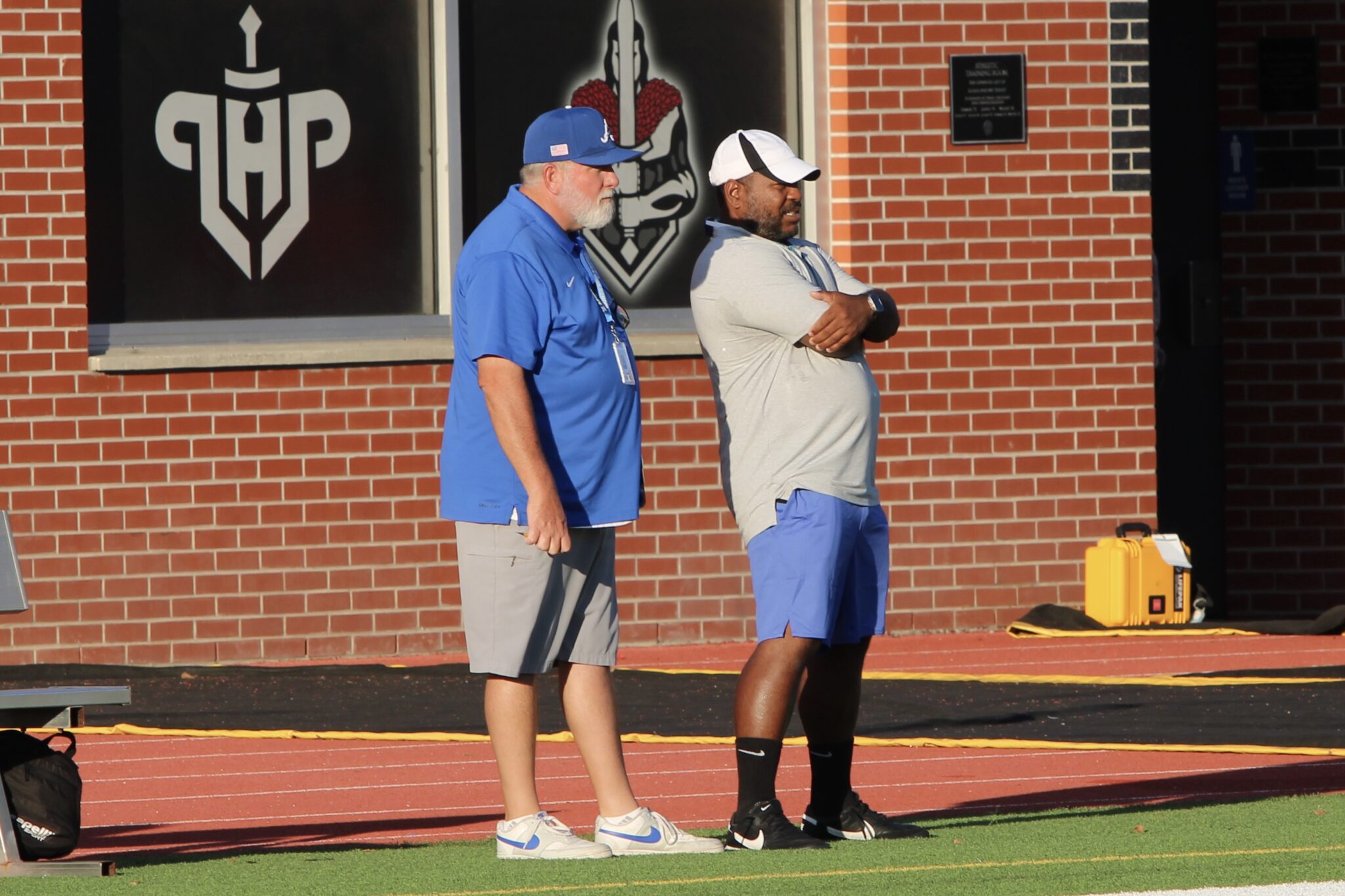 Coaches Tino Sangster and Joe Chandler watch their team in a game from last season.