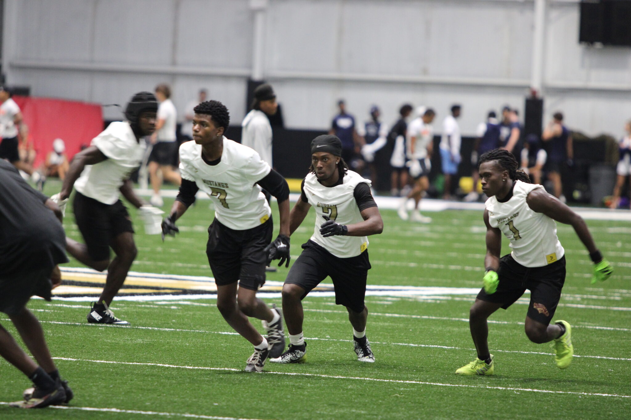 Givonny Bufford, Bakary Manley, and Dominique Walker break out of their tight trips formation.