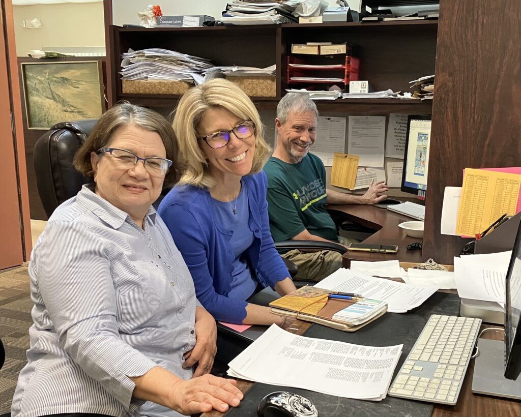 From left to right: legal clerk Lesbia Toruño, Mainstreet Daily News community partnership manager Janalyn Peppel, and Joey Ricketson pose for the camera.
