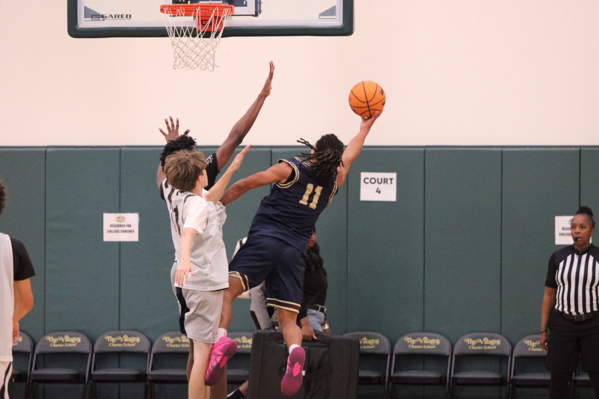 Jace Moore extends his body through contact for the finish and trip to the free throw line.