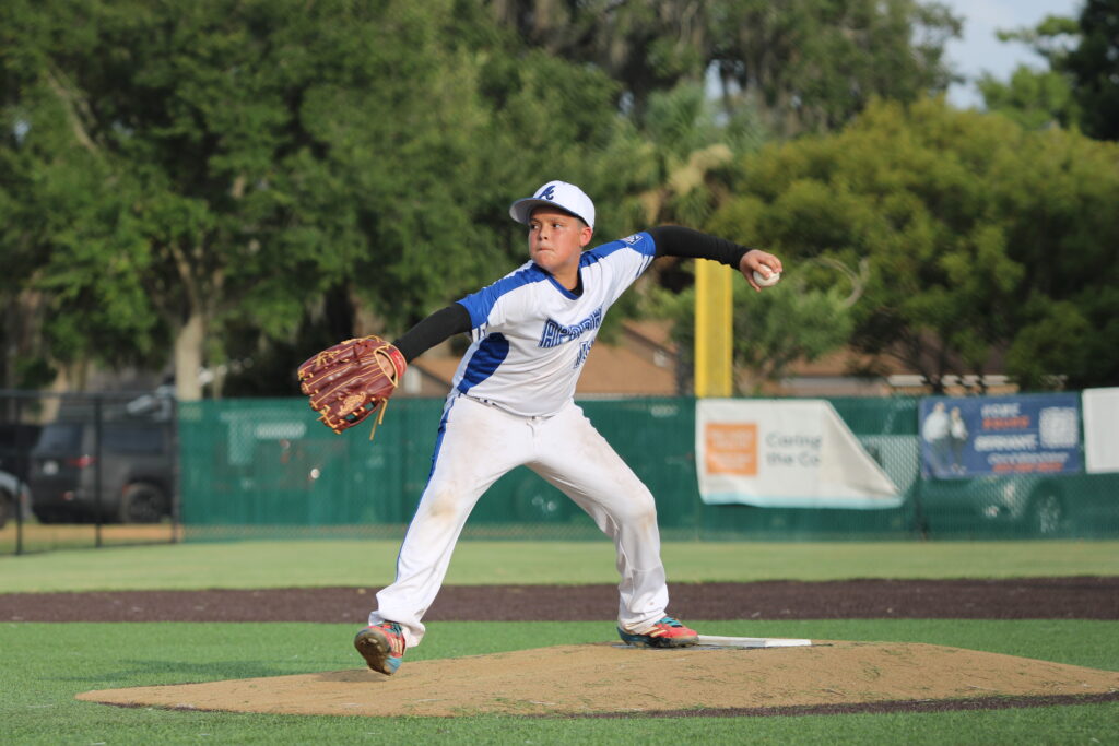 Jordan Childs steps through the mound and winds back a pitch.