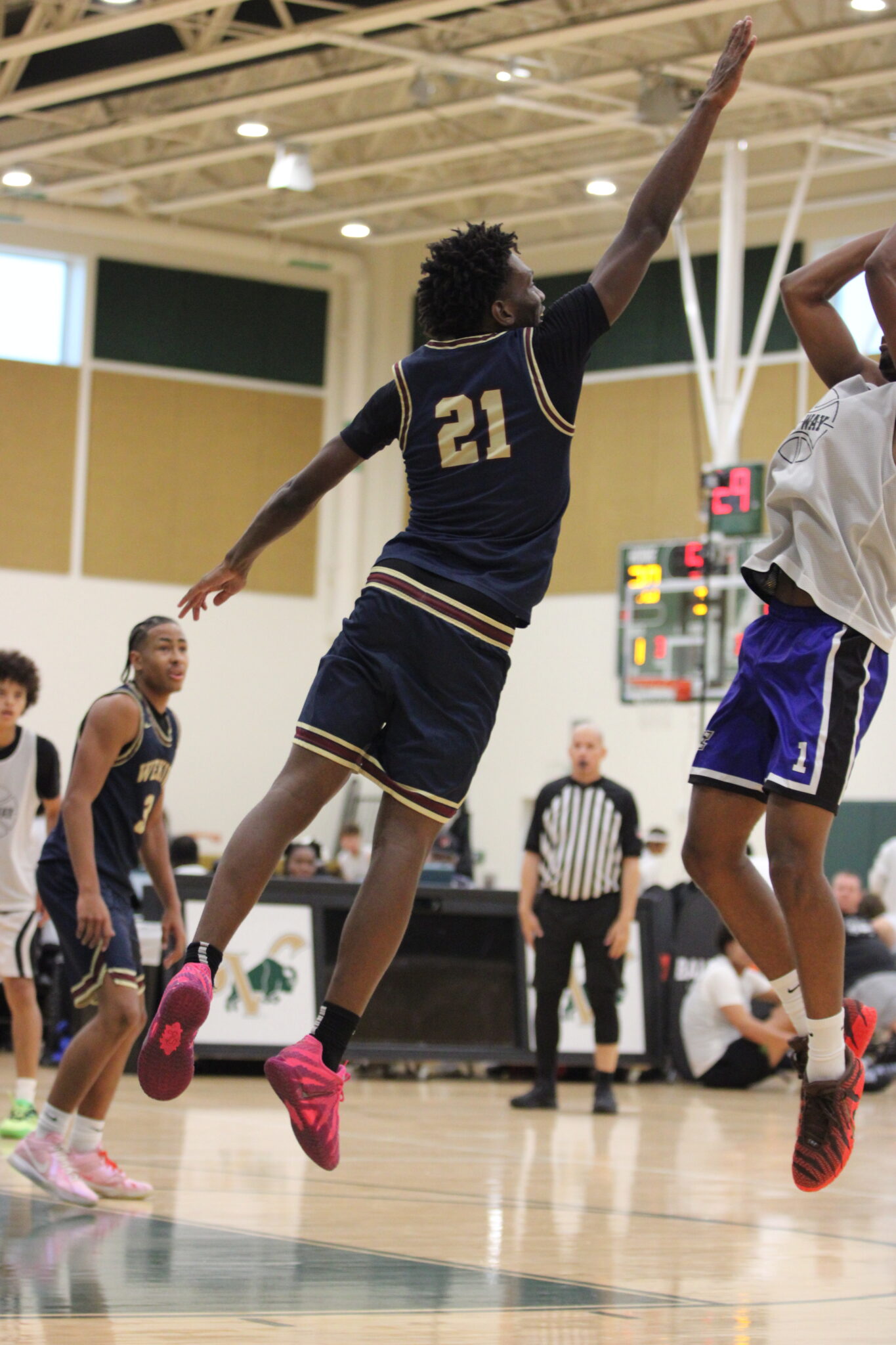 Kenny Dieujuste leaps out to try and swat a mid range jumper.