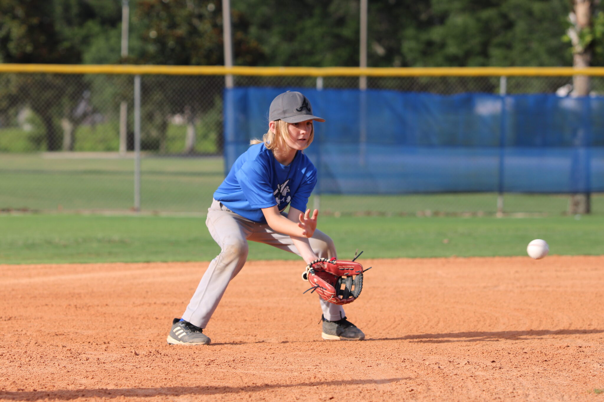 Matix Stirling fields a ground ball with alligator hands at third base.