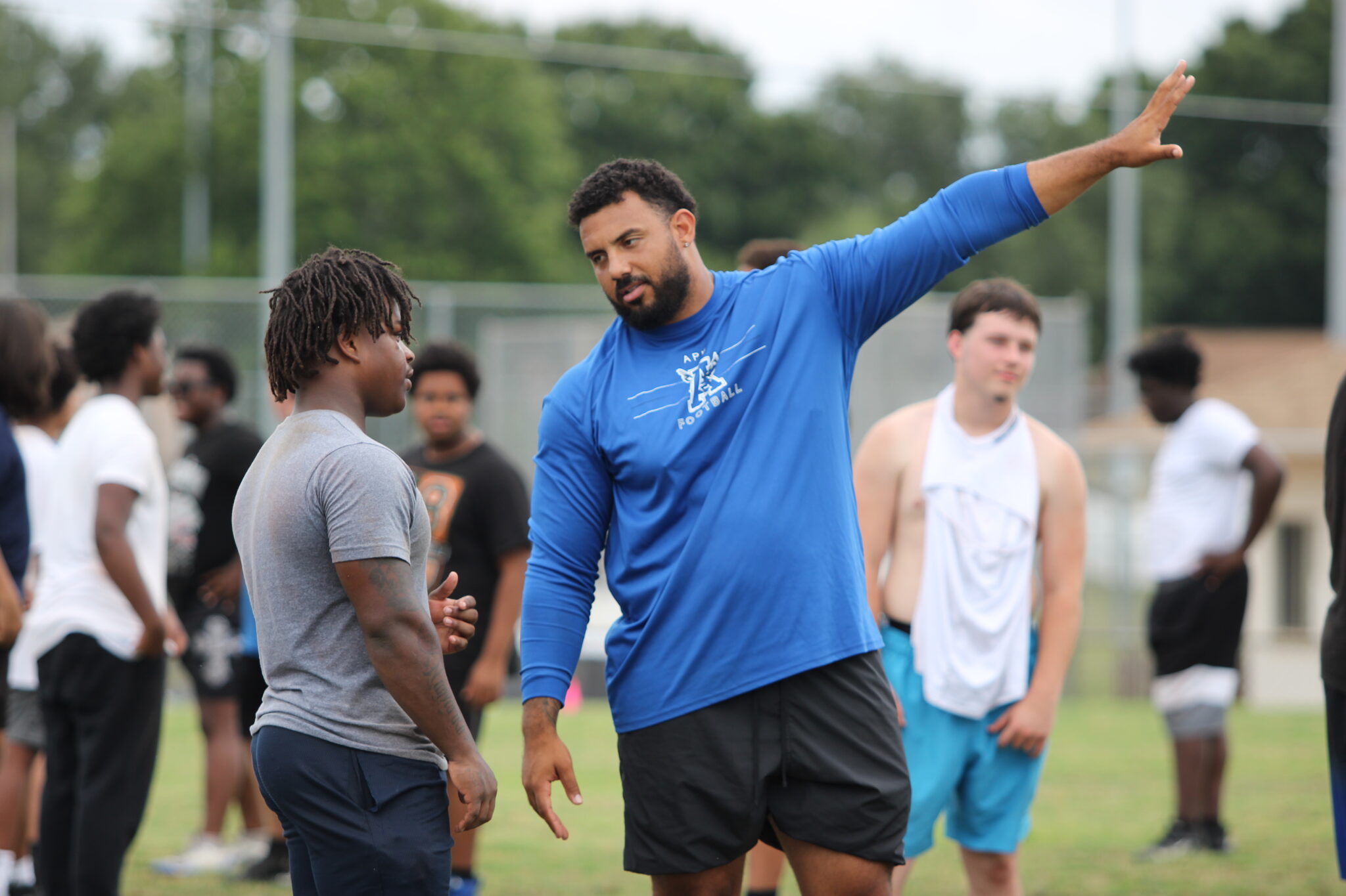 Offensive line Coach Janko Beras teaching an offensive lineman.