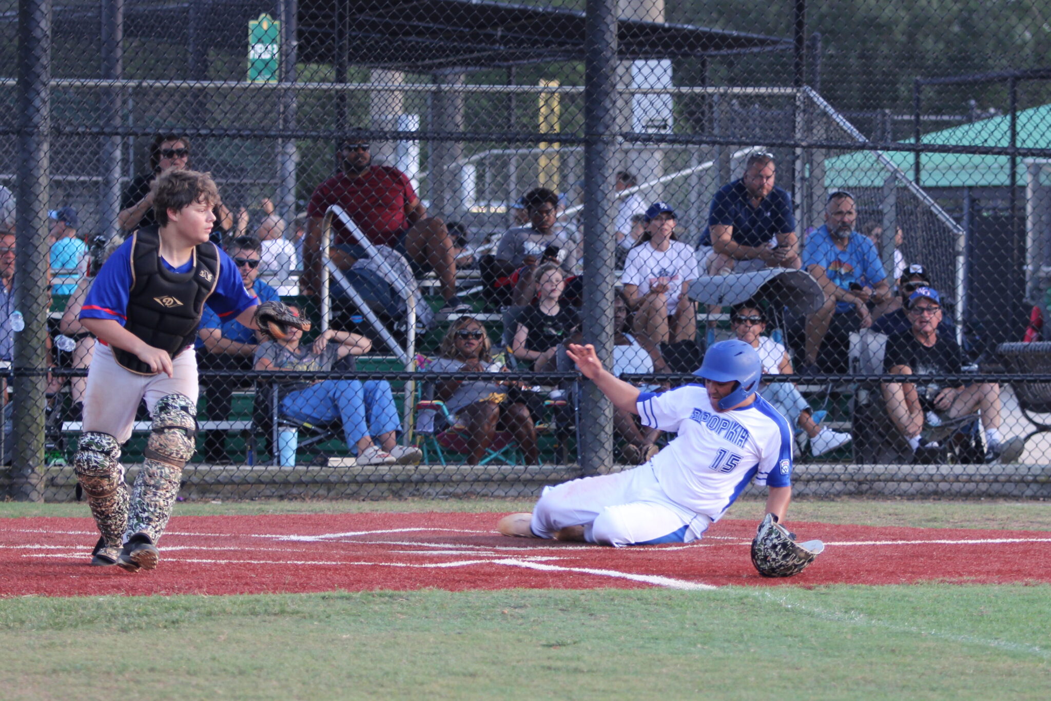 Sebastion Vasbinder slides safely into home plate for the first run of the game.