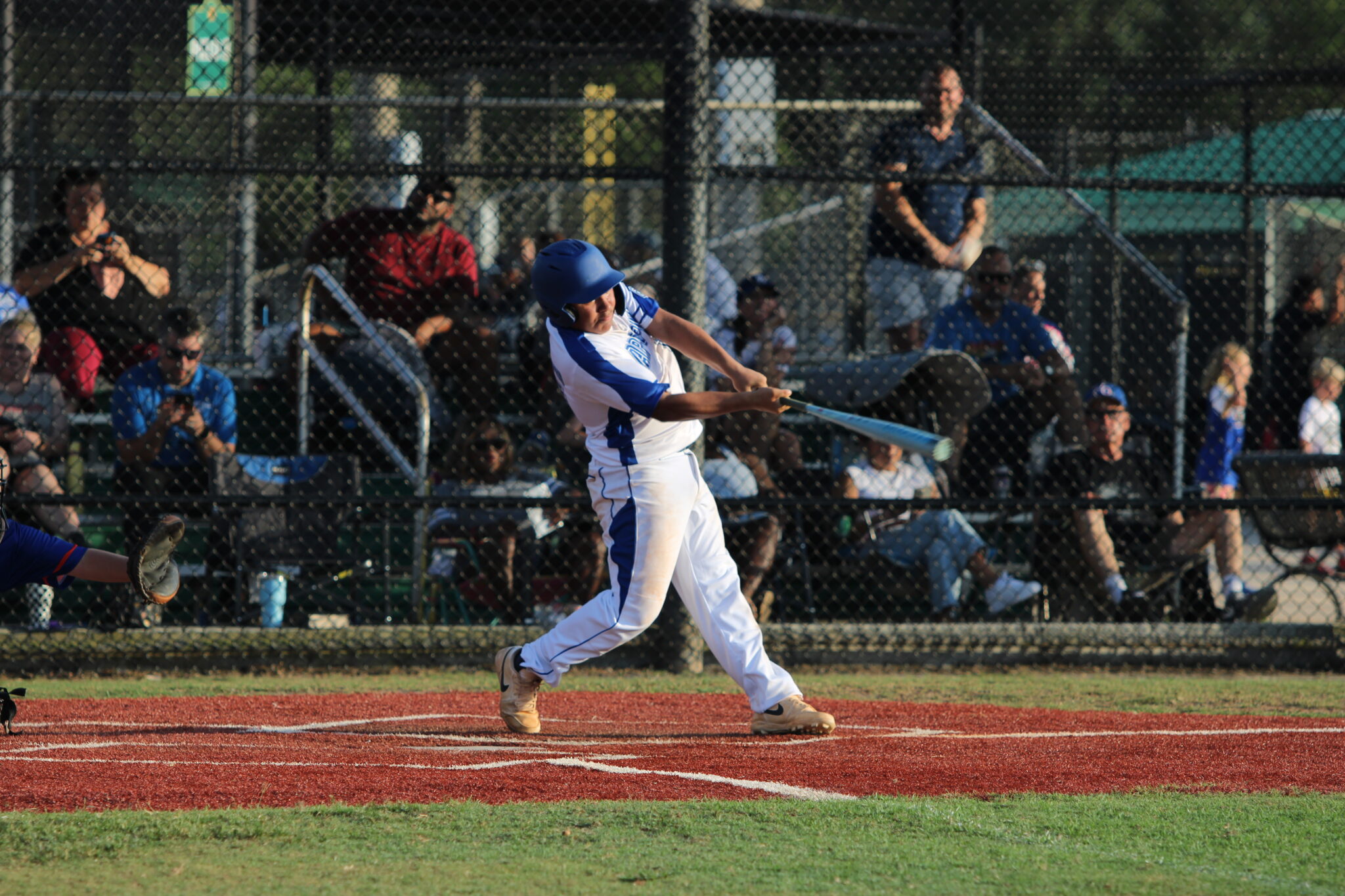 Sebastion Vasbinder swings through a pitch and rips it into the outfield.