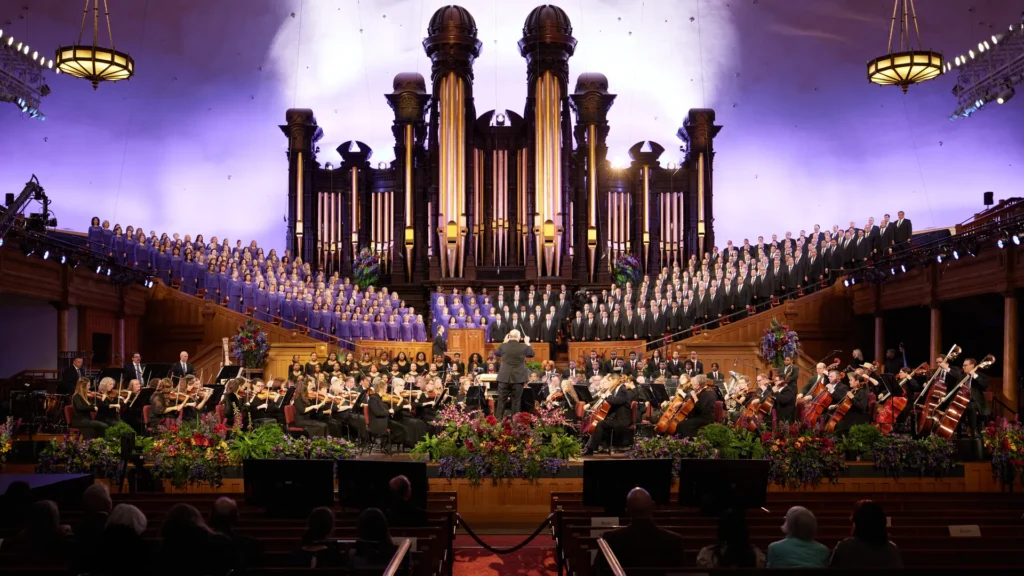 The Tabernacle Choir and Orchestra at Temple Square performs in front of its iconic organ pipes. Local Latter-day Saint congregations are hosting a free community watch party this Friday to broadcast the choir's historic 100th-anniversary performance live from the Hollywood Bowl.