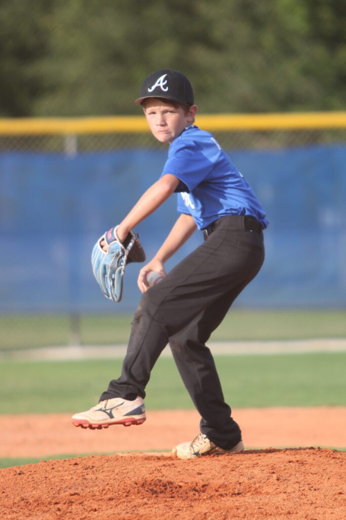 Tanner Adams winds back a pitch from the stretch.