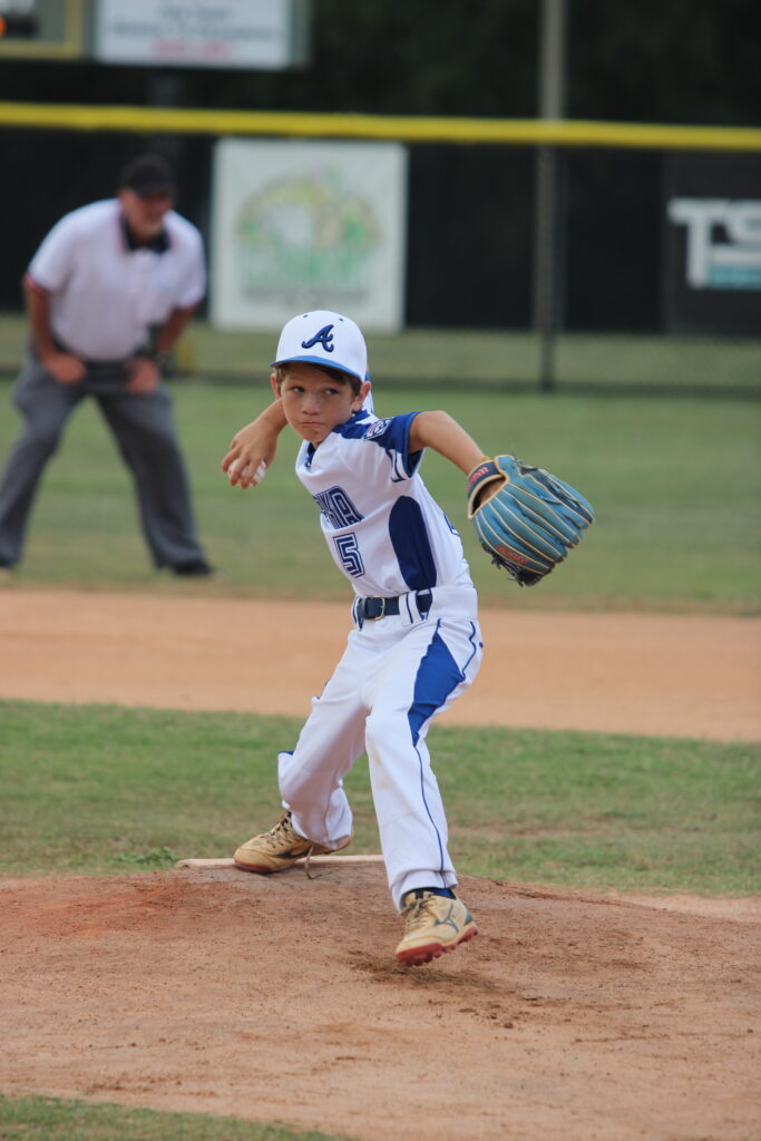 Tanner Adams winds back to whip in a pitch in the first inning.