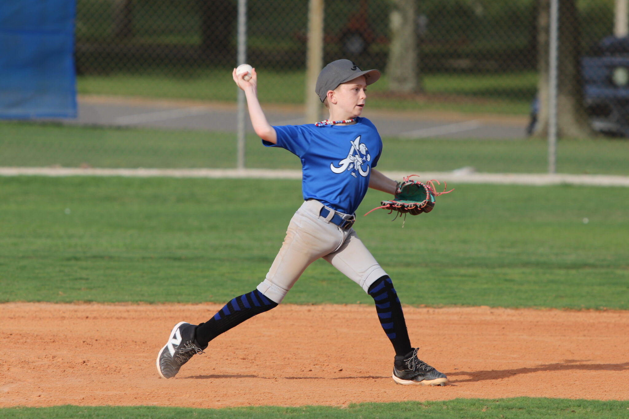 Tucker Little throws to first after fielding a ball at second base.