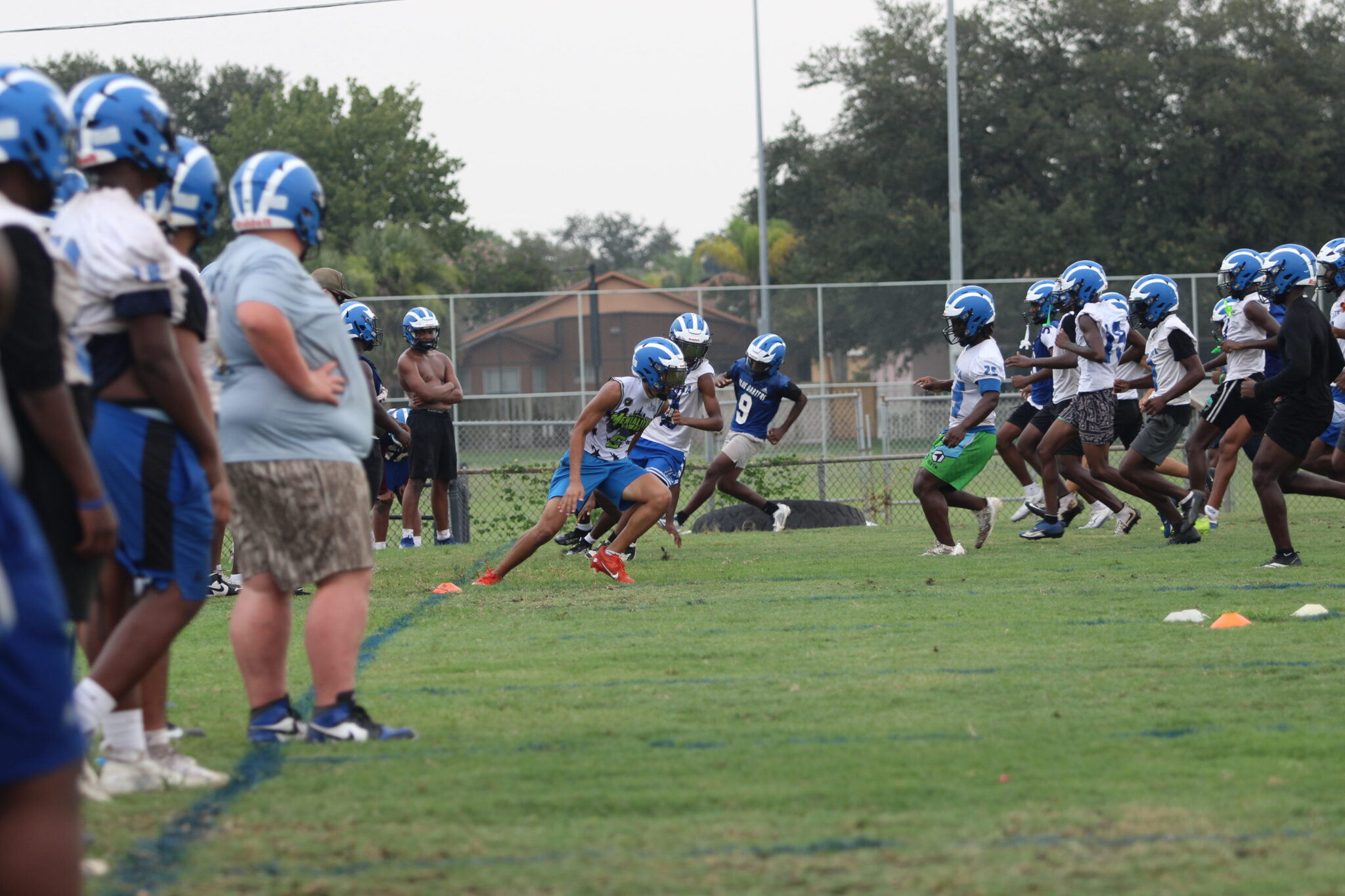 Apopka Blue Darters run conditioning on the practice field.