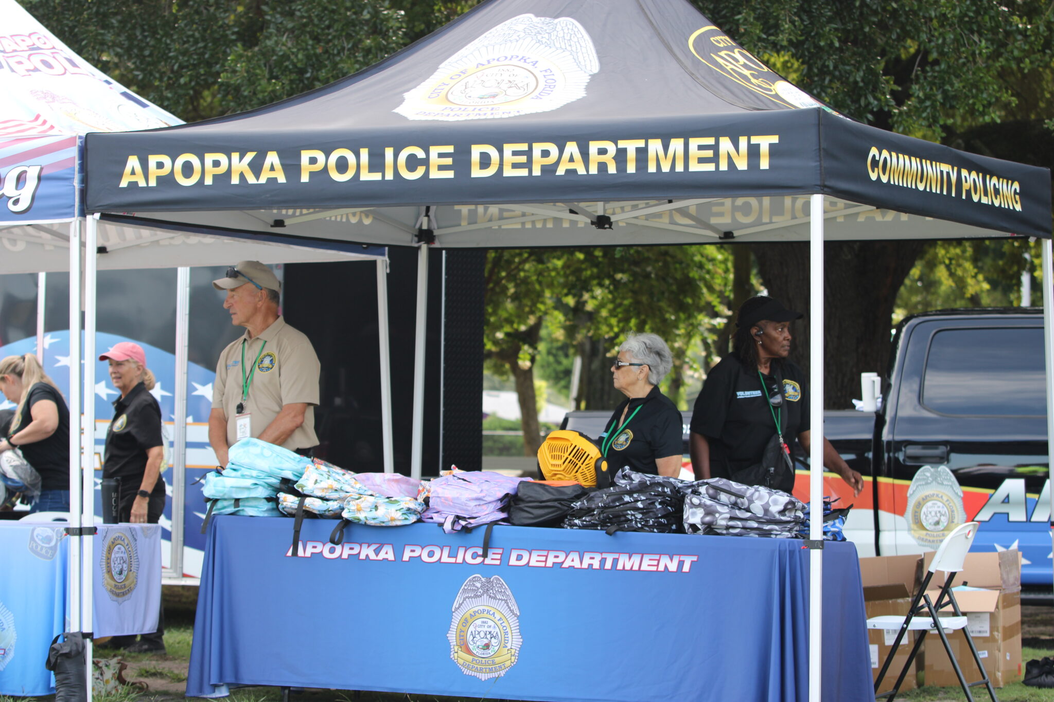 Apopka Police Department booth holds free backpacks for the kids going back to school.