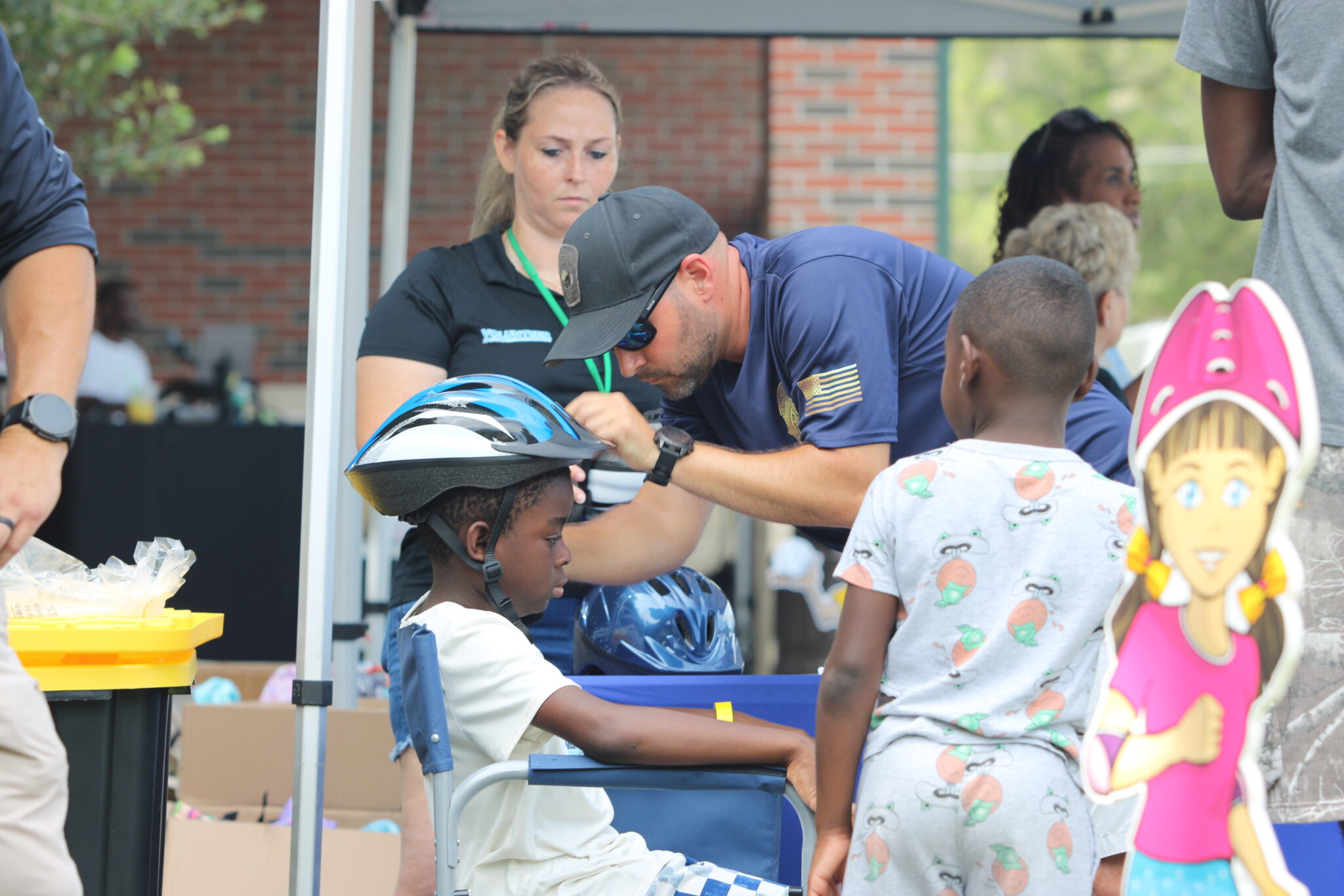 Apopka Police Department gives out free bike helmets to the youth and helps make them fit.