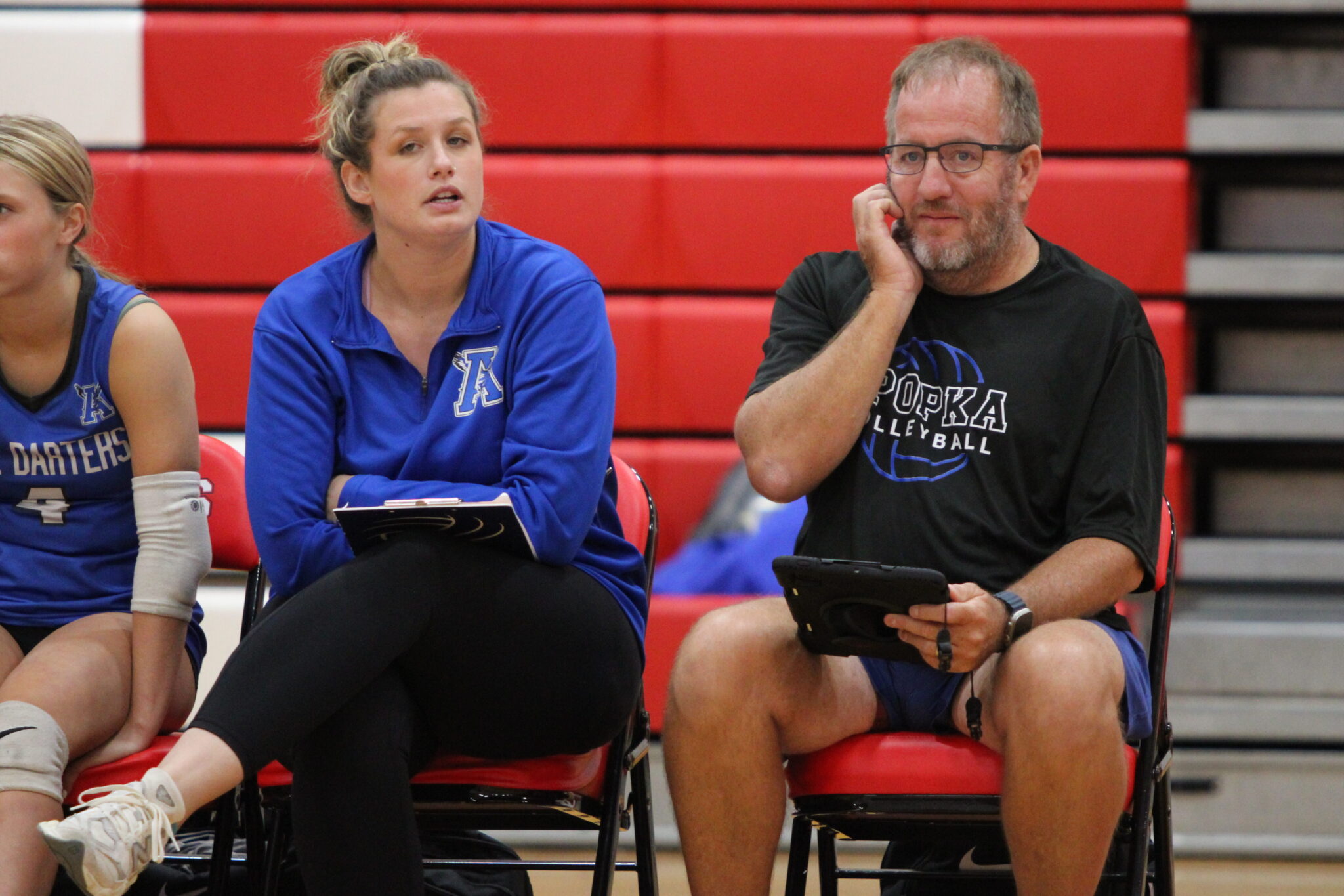 Apopka Volleyball coaches Sarah Egbers and Brian Mater communicating on the bench during a game last season.
