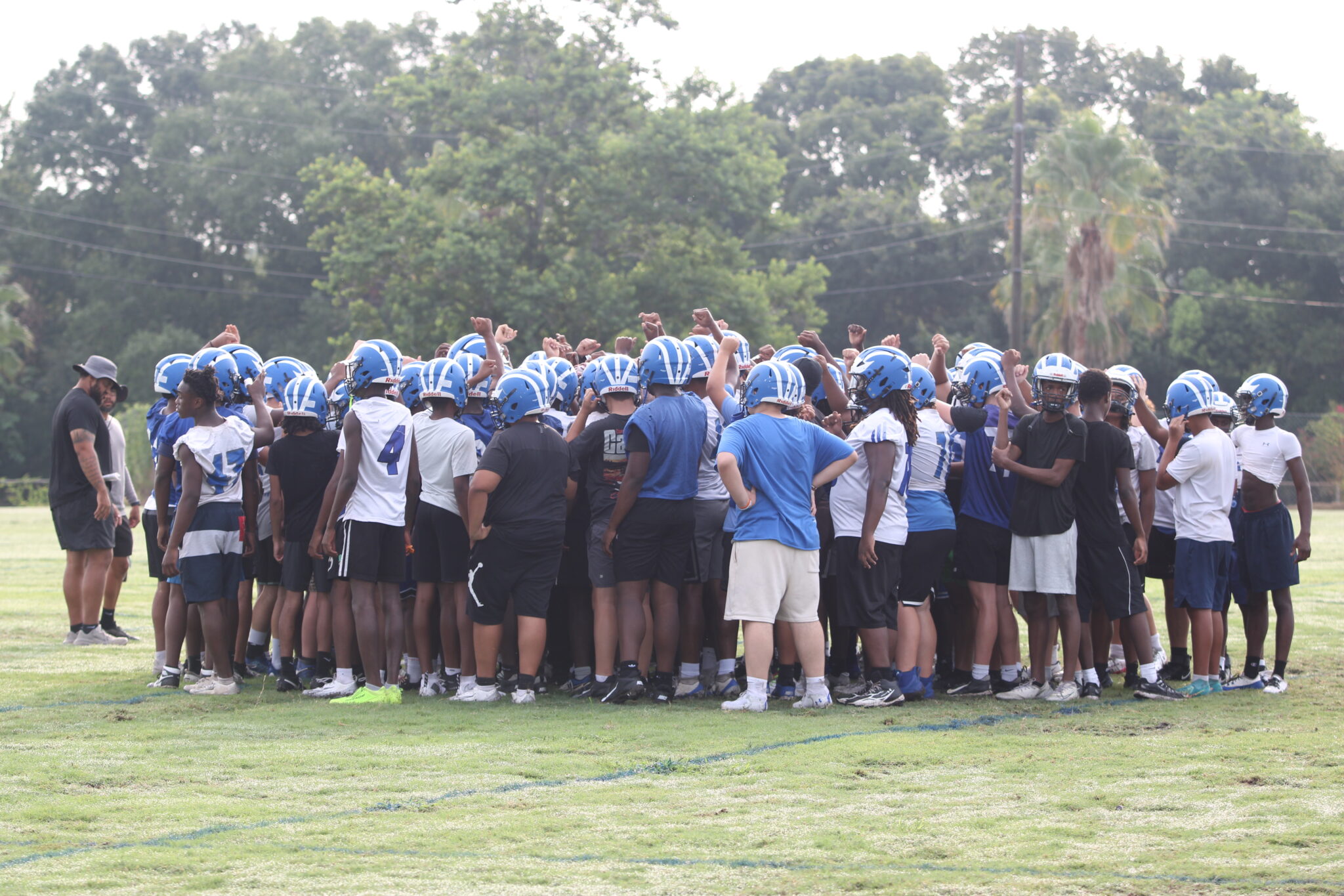 Blue Darters full roster huddles up on the first day of practice.