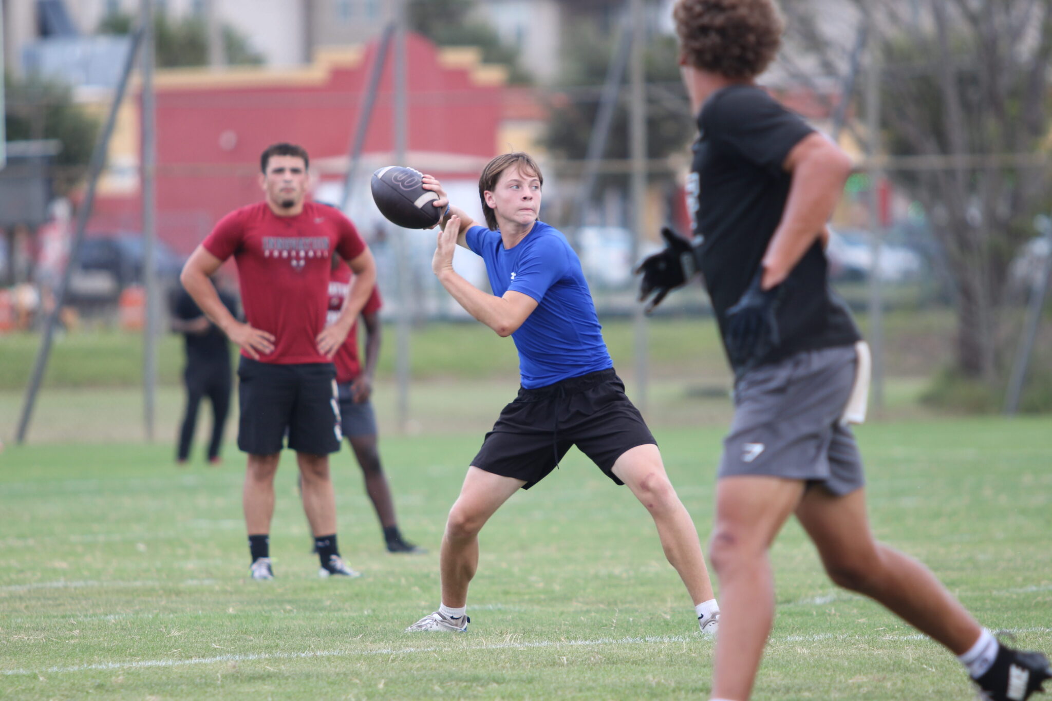 Junior QB Brodie Bolly winds back a pass in 7-on-7 at Jones High School.