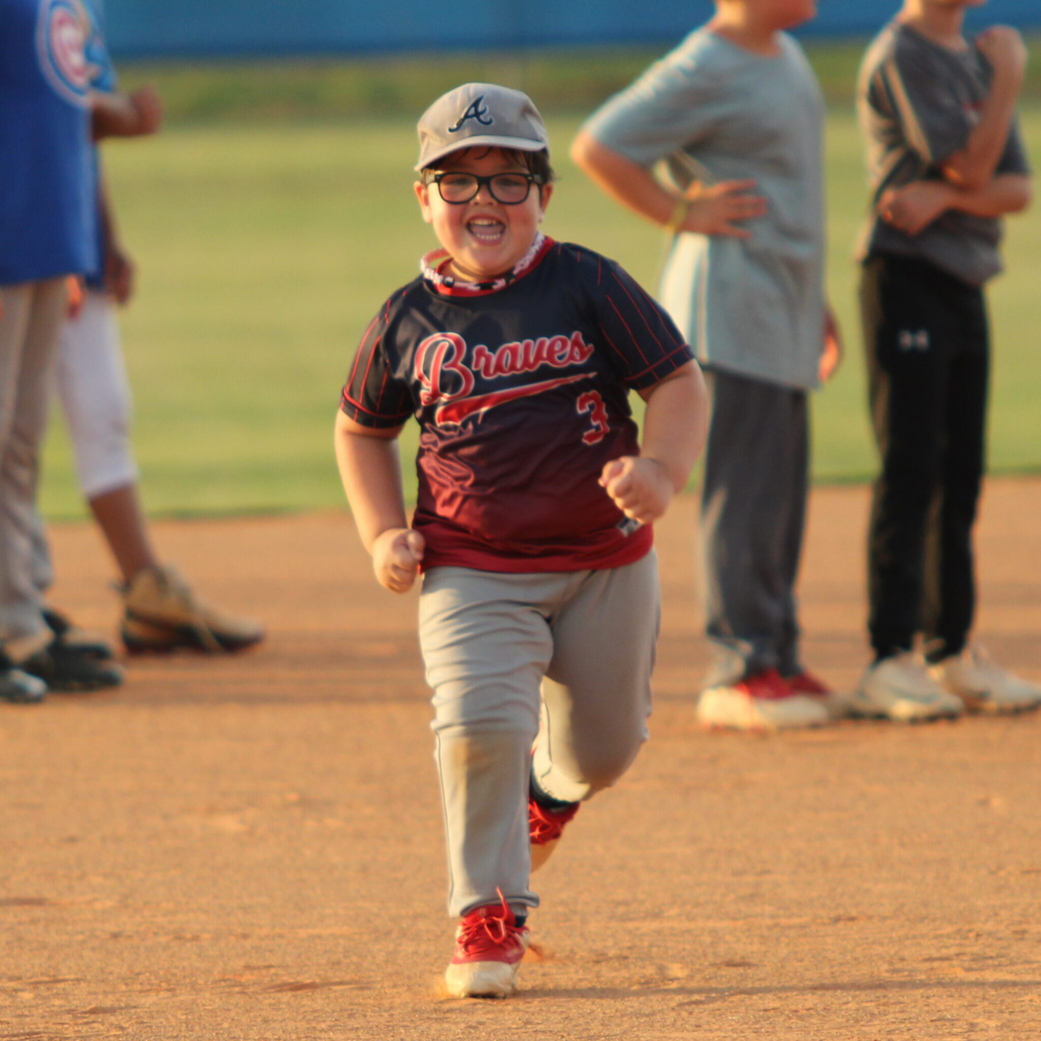 Camp youngster loving every moment of his trot through the bases in the relay race to finish camp.