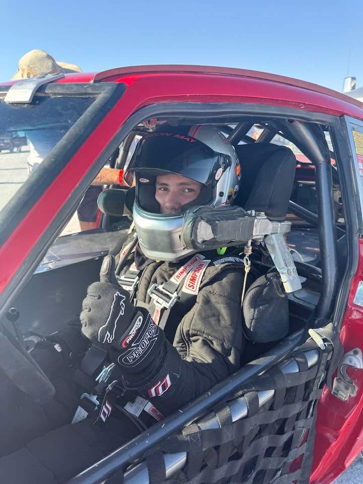 Carson May in the driver seat of his 1972 Datsun at Bonneville Salt Flats.
