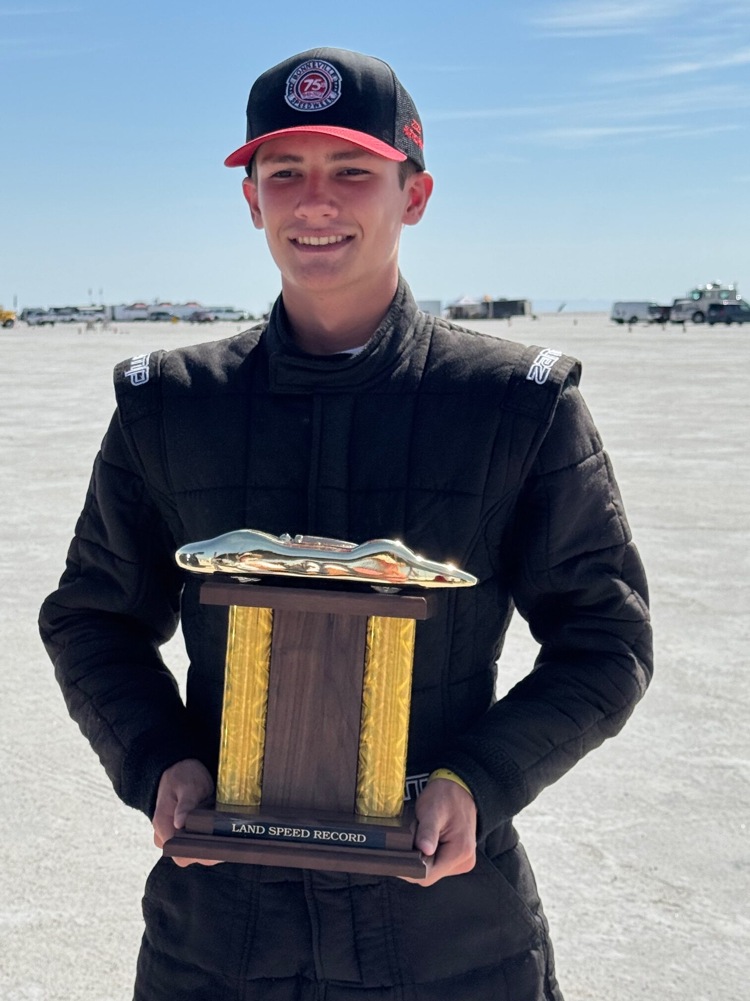 Carson May stands with the land speed record trophy at Bonneville Salt Flats.
