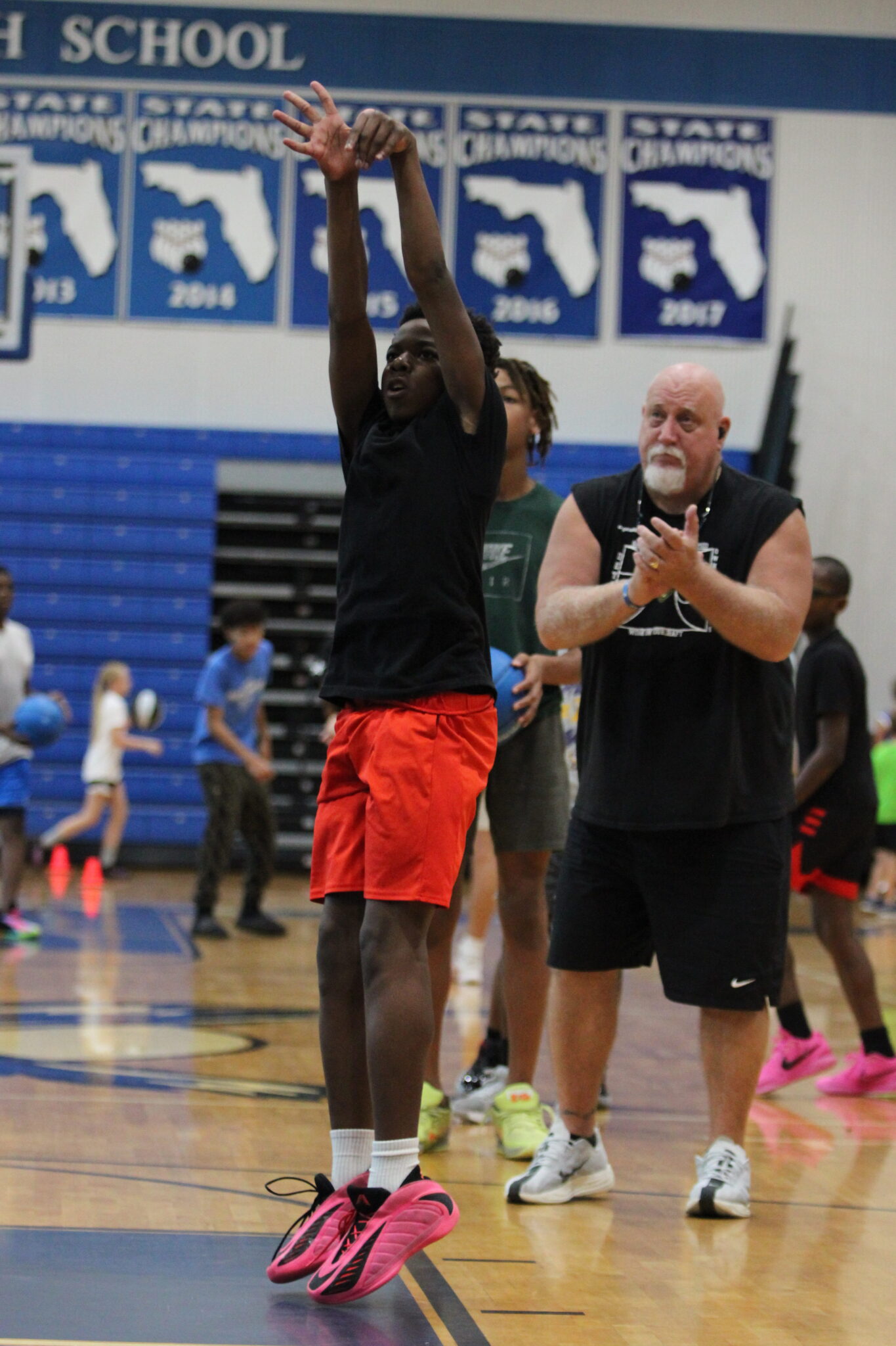 Coach John 'Sarge' Siers works with campers on shooting off the dribble.