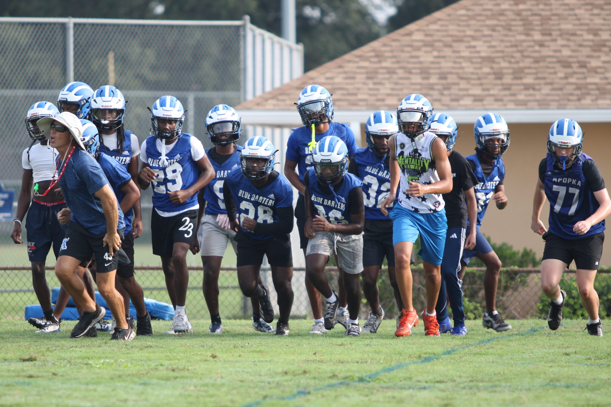 Defensive Back group sprints off the field together after their drill.