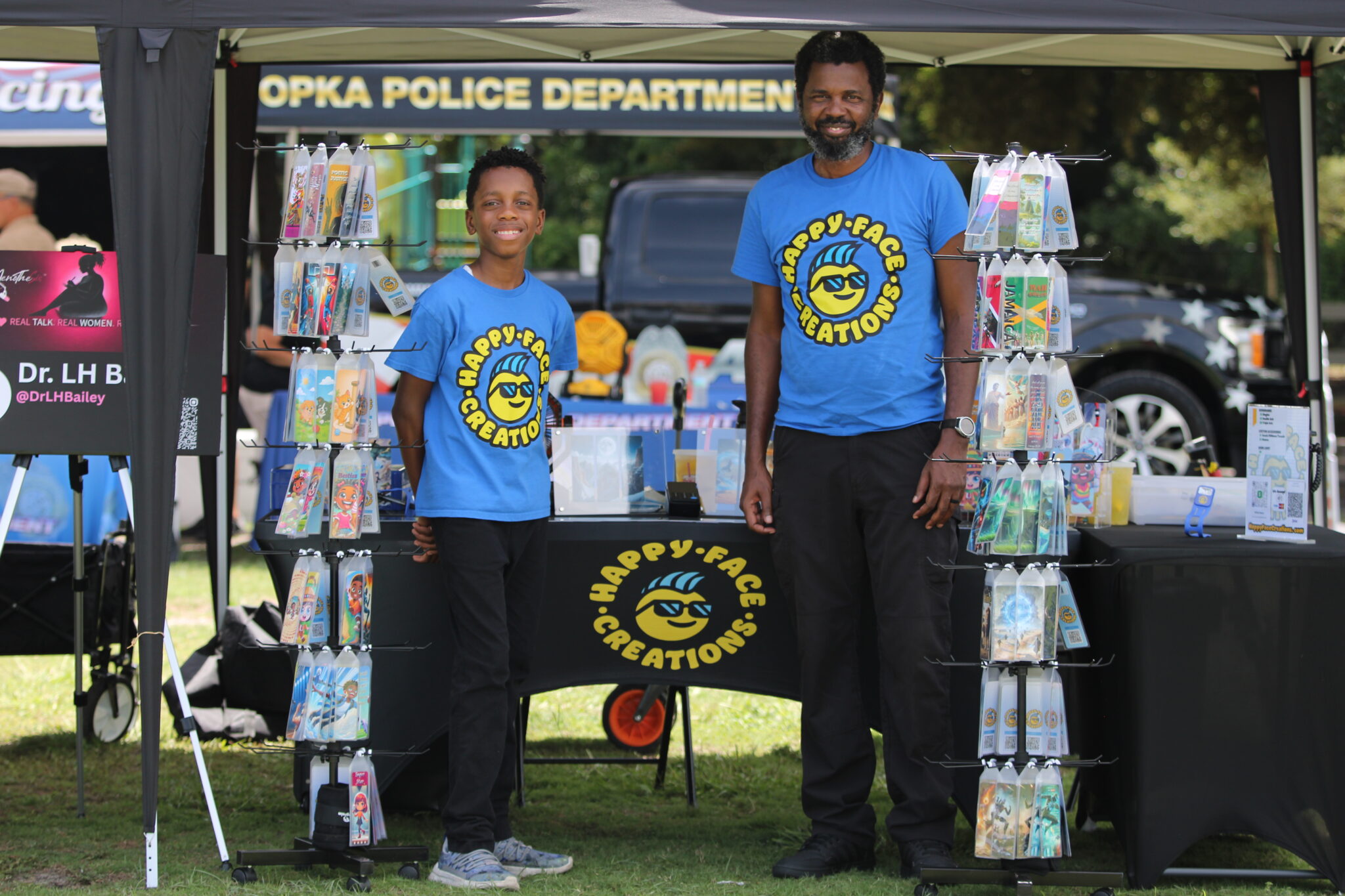 Father and Son Wilfred Bailey II and Wilfred Bailey III host the Hapy Face Creations vendor at Apopka Community Sports Day.