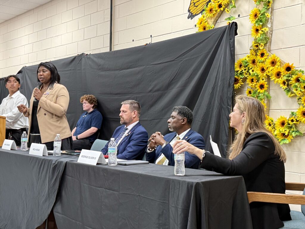 Orange County Commission District 2 candidate Kamia Brown speaks at the June 18 Hope CommUnity Center candidate forum as fellow candidates Wes Hodge, George Oliver and Marsha Summersill look on.