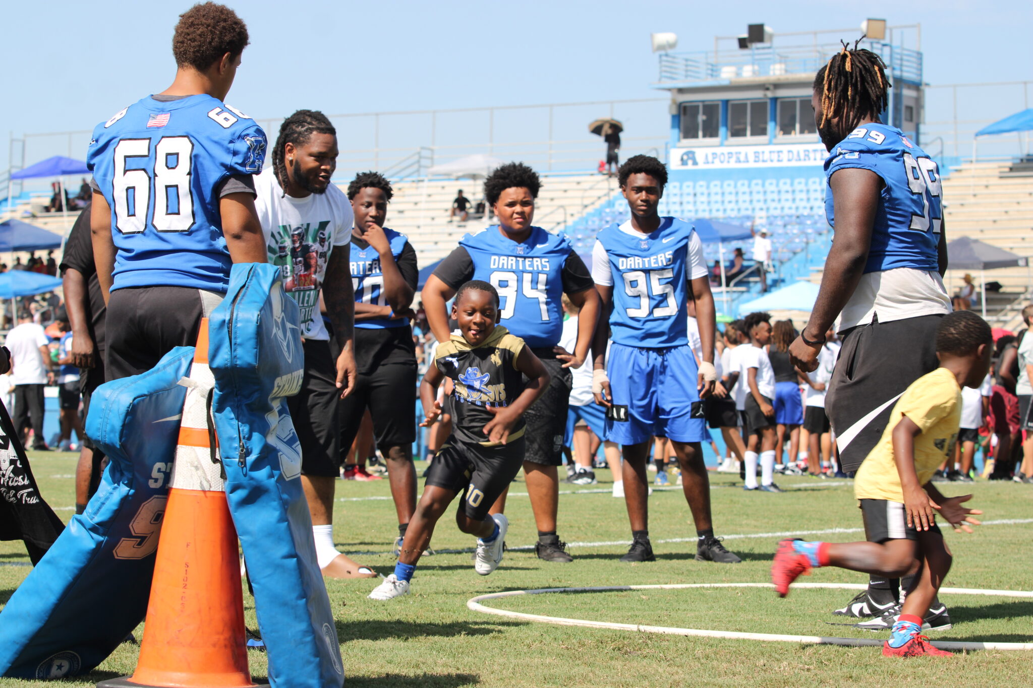 Jalen Carter and Senior Defensive lineman Demetrius Tarpley (99) work with campers on tight turning in a tag game.