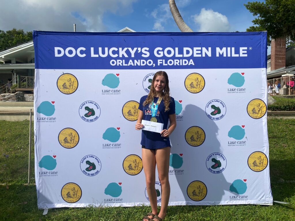 Keira Druck standing as the women's champion of Lucky's Golden Mile.