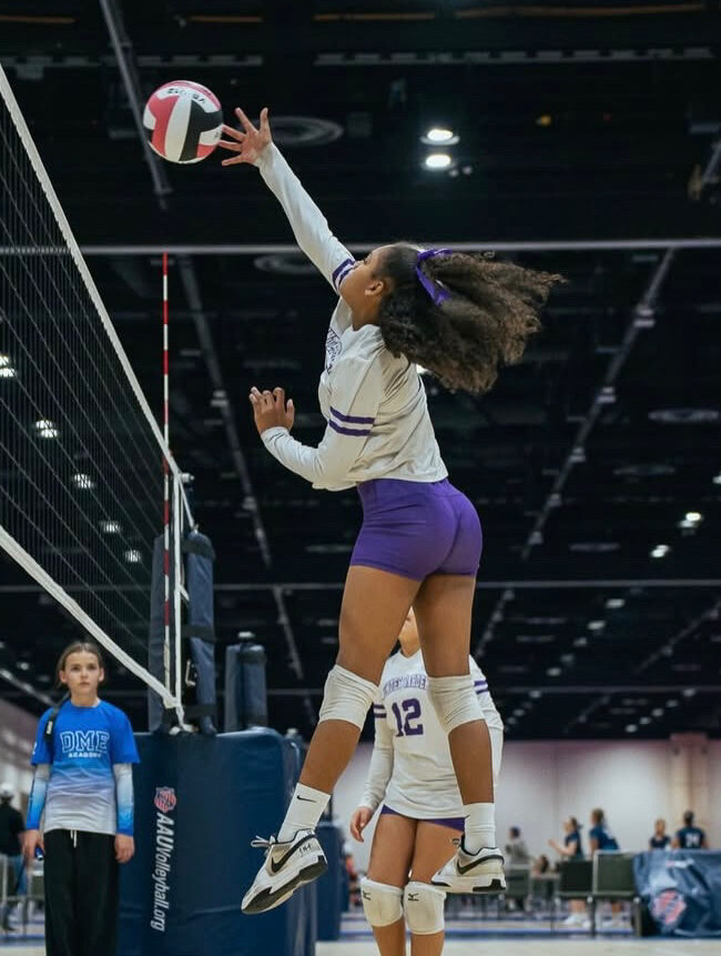 Khloie Berry smashes down a kill at the middle of the net during the US junior national championship in Minnesota.