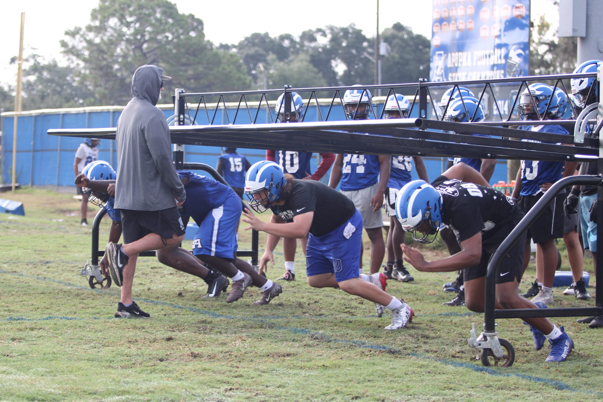 Matt Anderson works with the defensive line on exploding low out of their stance.