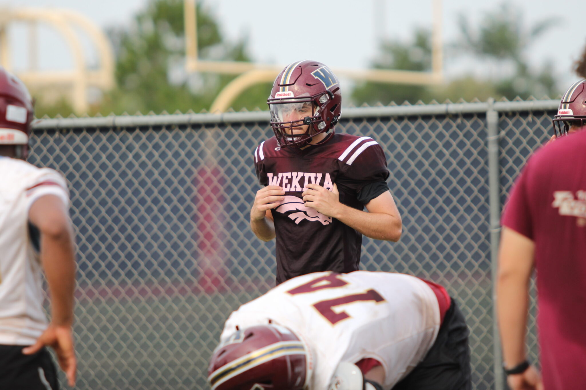 Mustangs QB Dominick Sanguine listens to the offensive line call outs during the pre-snap.