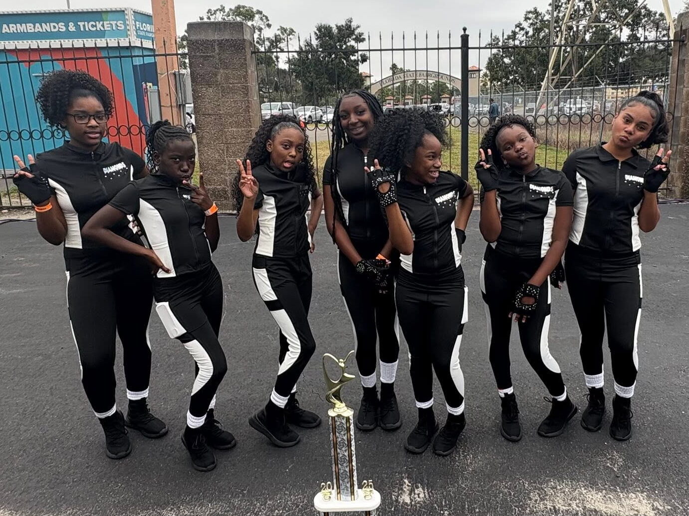 Pure Pressure Cheer and Dance Diamond group poses with a trophy.