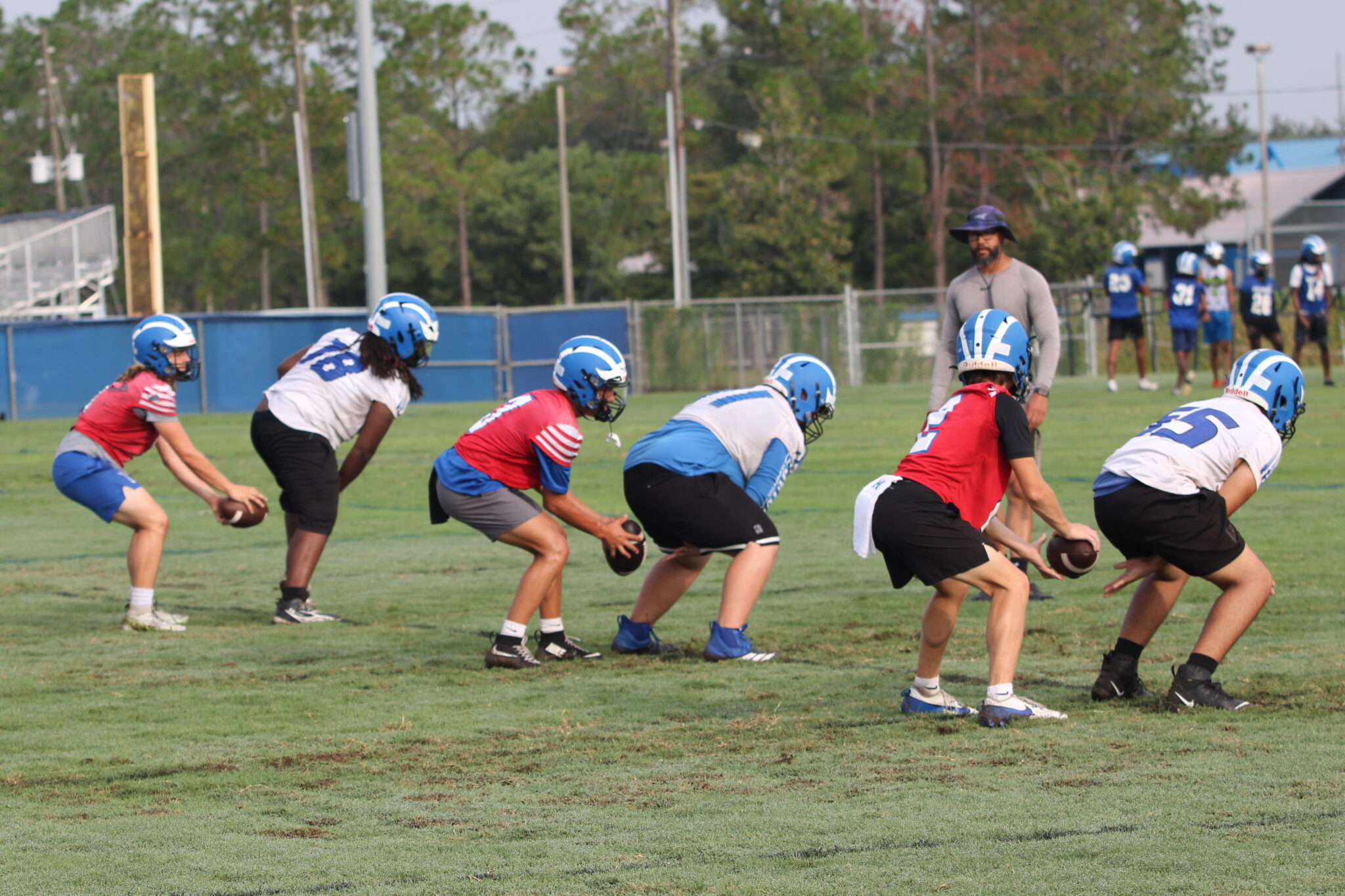Quarterbacks and centers perfecting the snap under center.