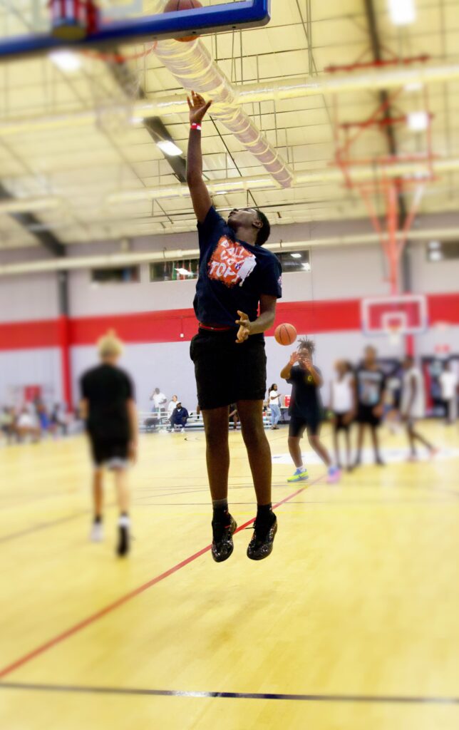 Young athlete takes a layup during drills at the Time to Train youth basketball clinic at The Well Activity Center in Apopka.