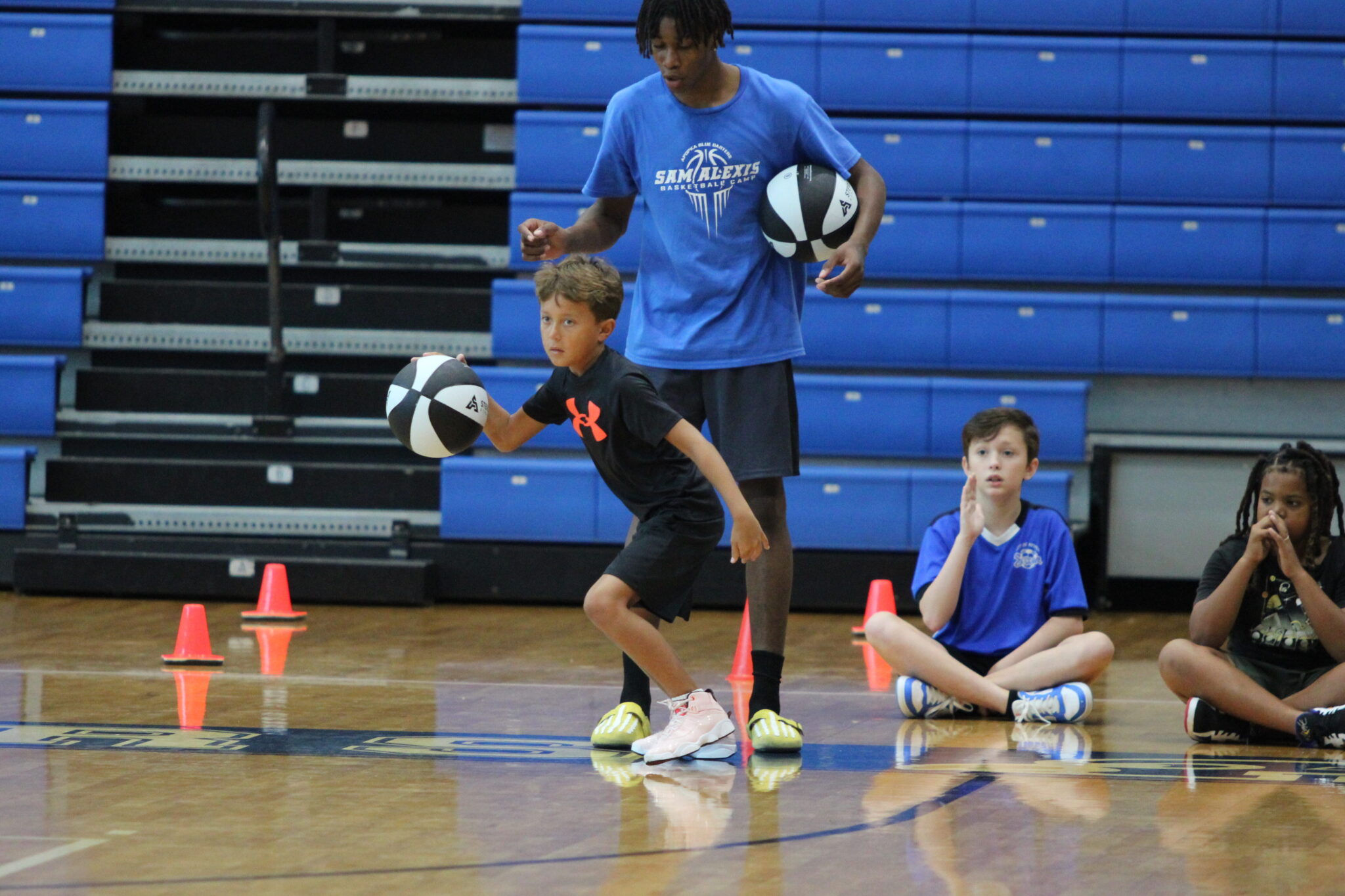 Young camper runs through the dribble competition to try and reach the finals.