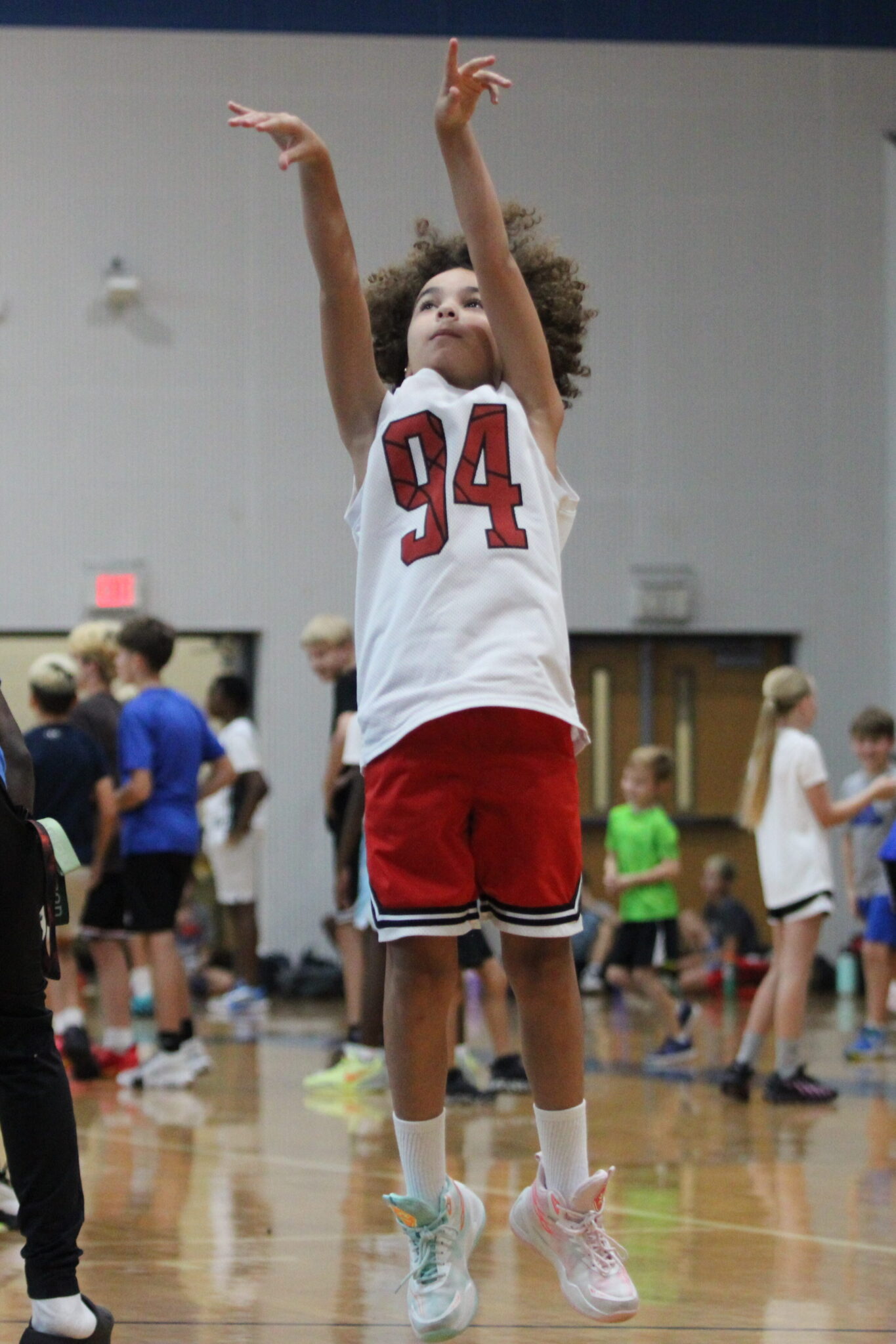 Young camper takes a dribble pullup around a current Blue Darter.